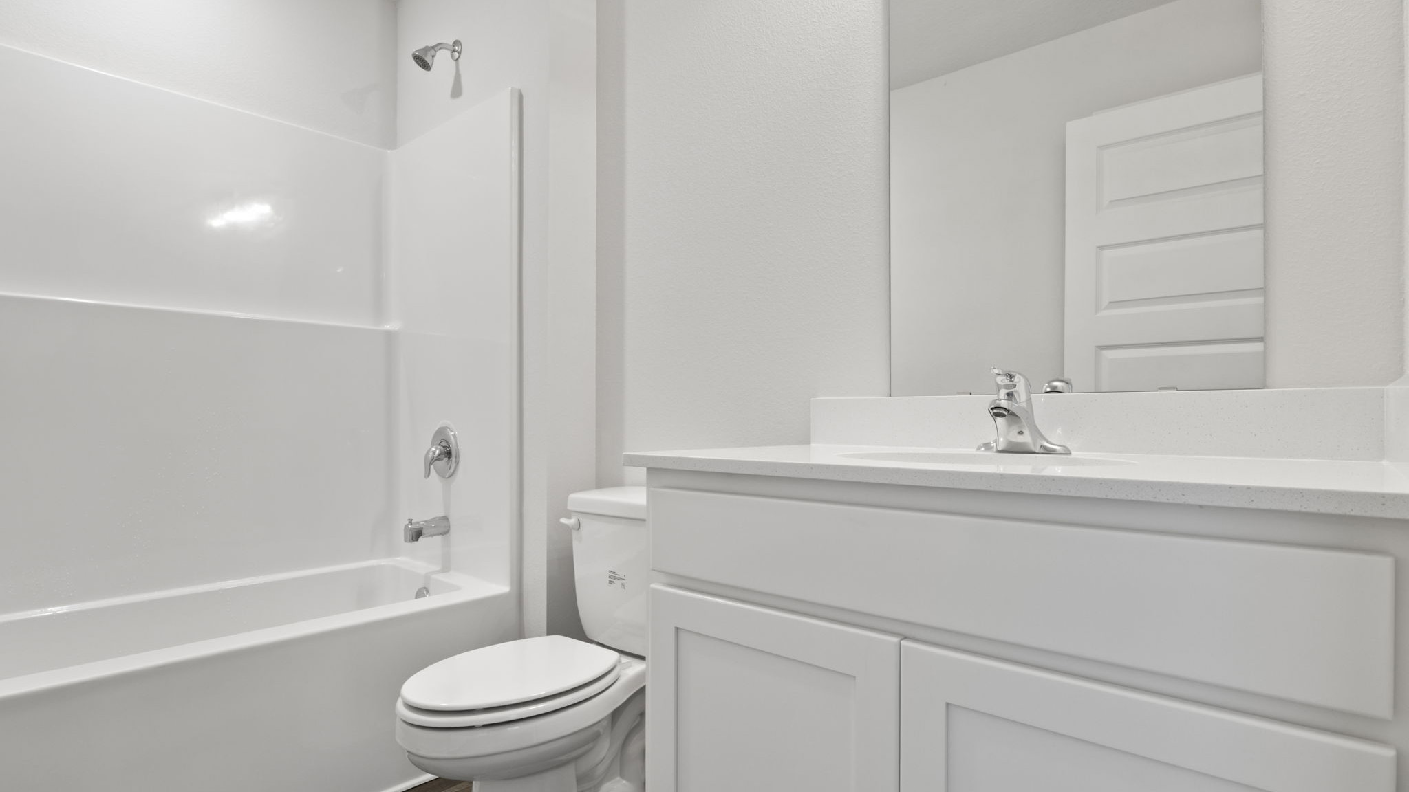 The shared bathroom for guest bedrooms two and three has a single vanity and shower tub combination