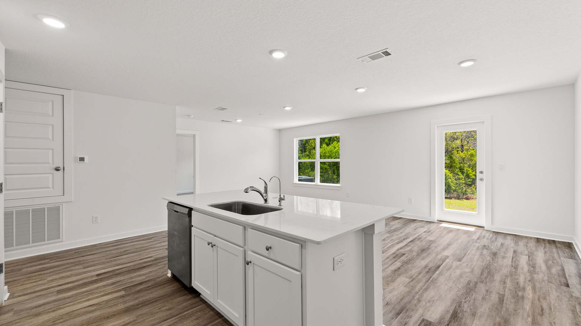 The kitchen looks out to the dining and living area