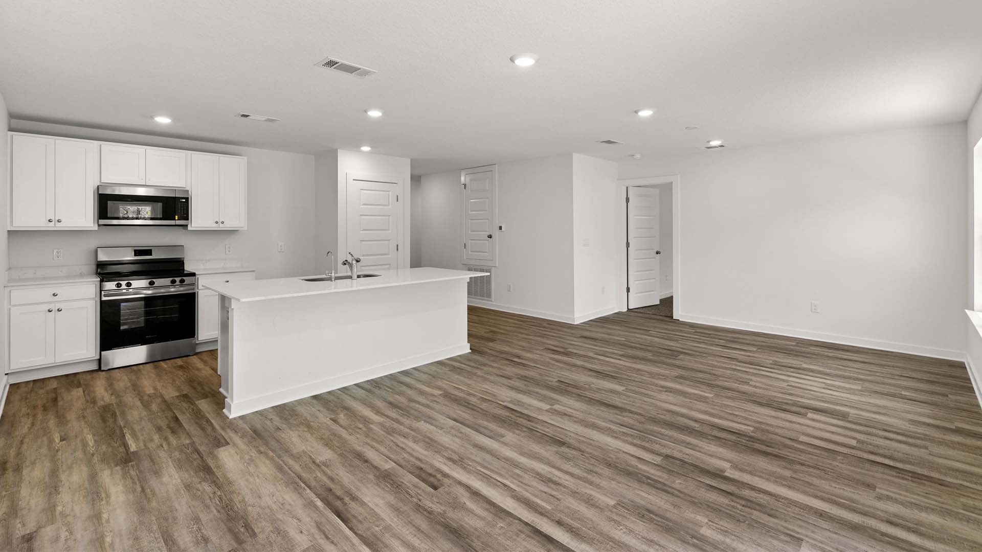 The kitchen has appliances including a stove microwave and dishwasher