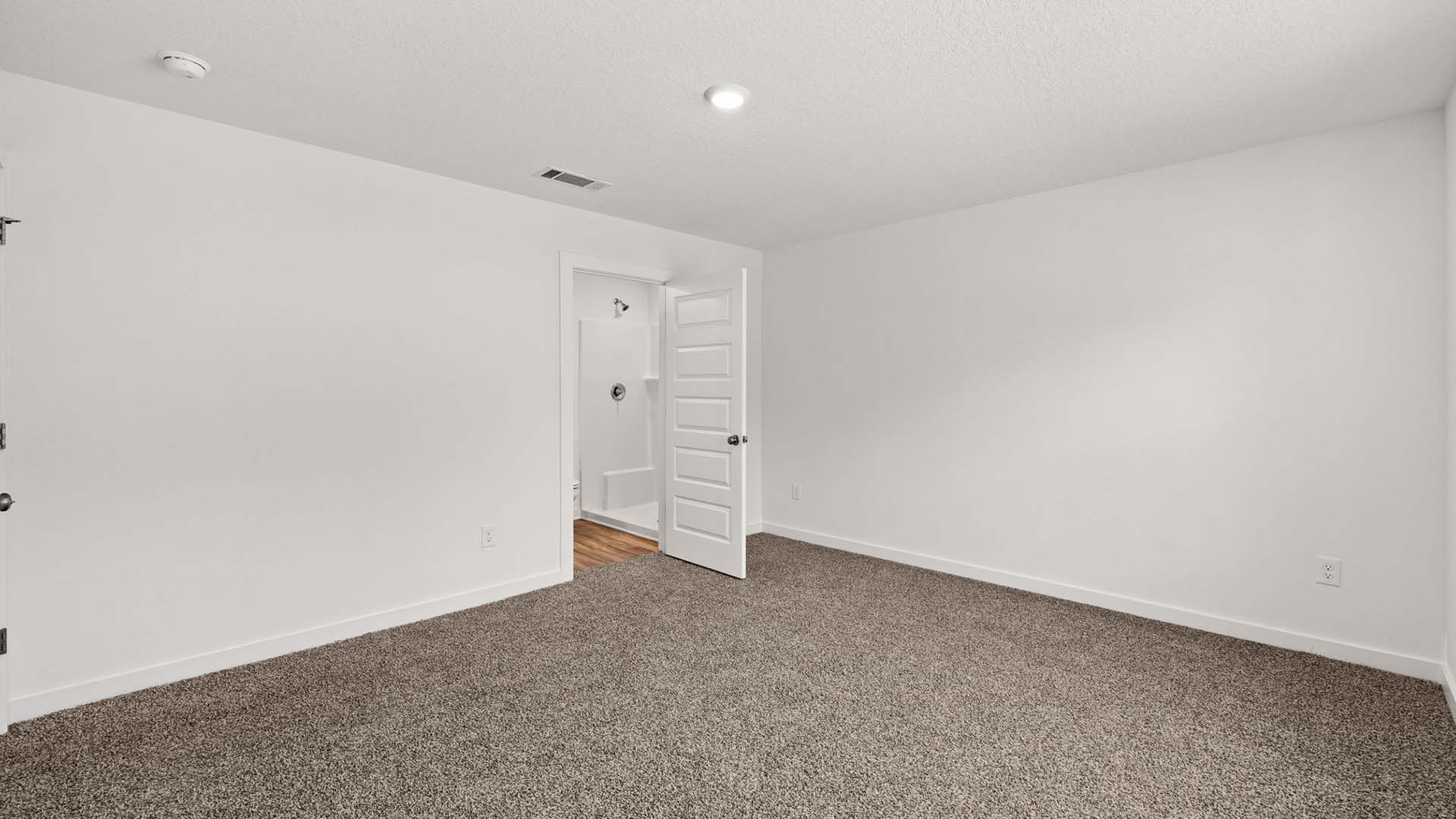The primary bedroom has a private ensuite bathroom