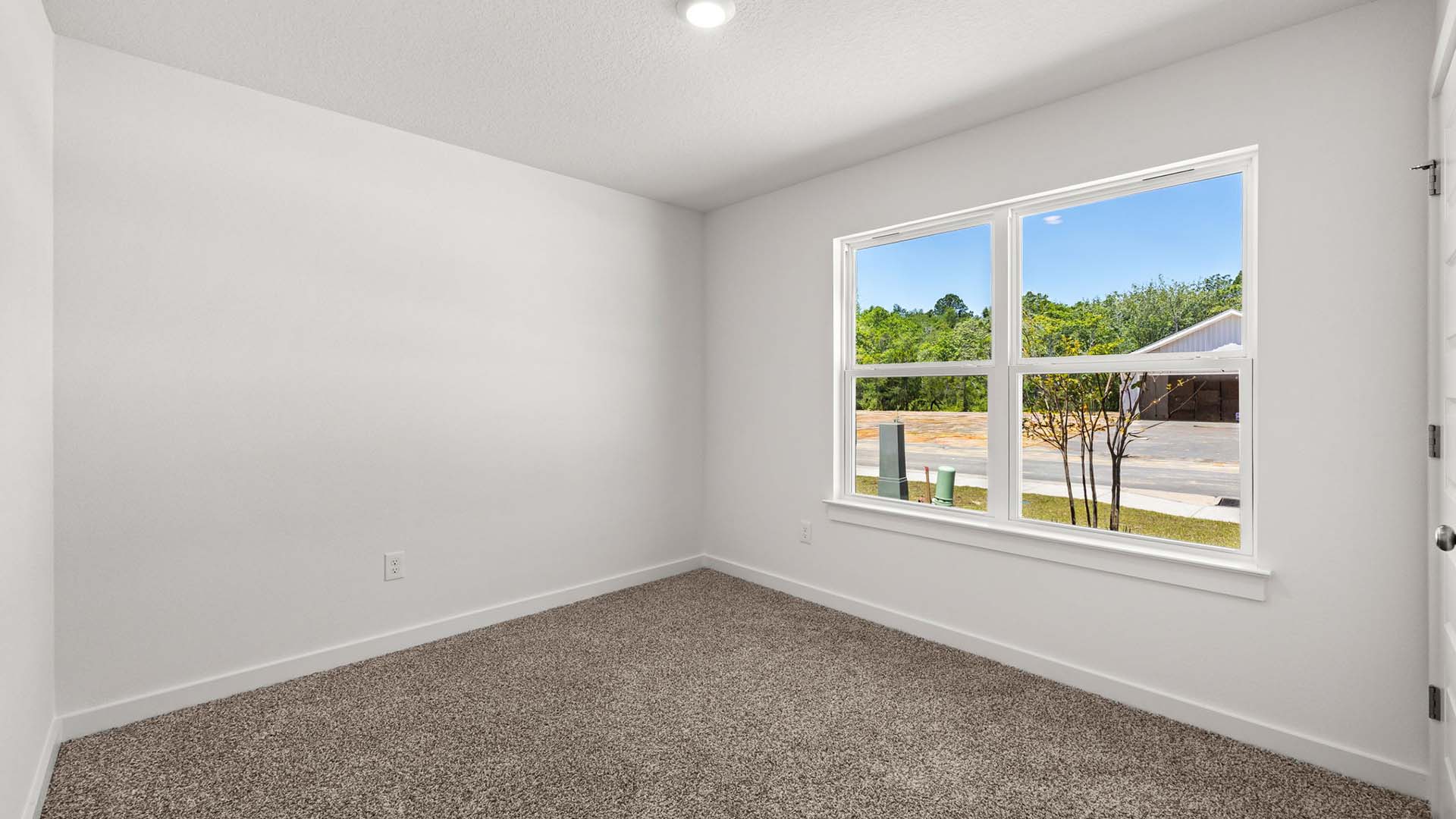 Guest Bedroom with carpet at the front of the home