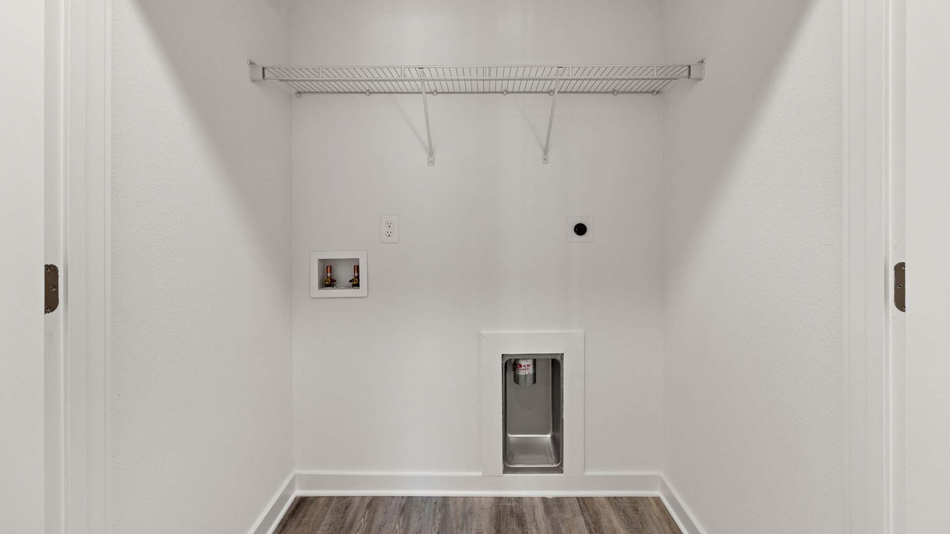 The laundry room has space for a full size washer and dryer