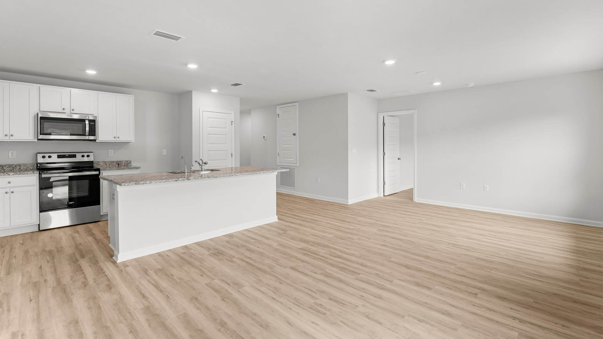 The spacious living area is open to the dining with EVP flooring