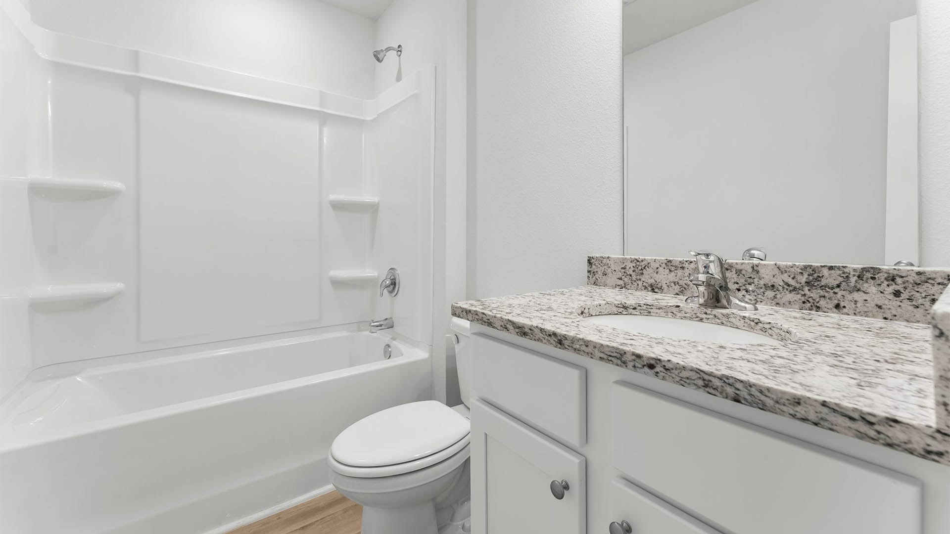 The shared bathroom of three bedrooms has a shower tub combination