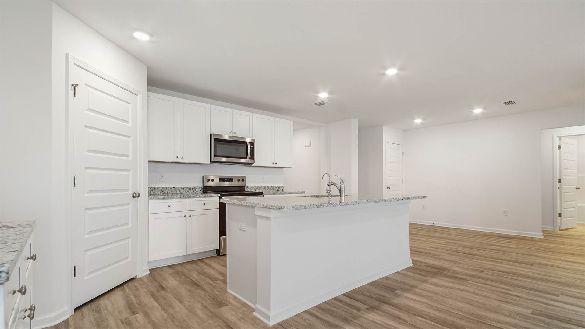 Kitchen with stainless steel appliances including a stove microwave and dishwasher