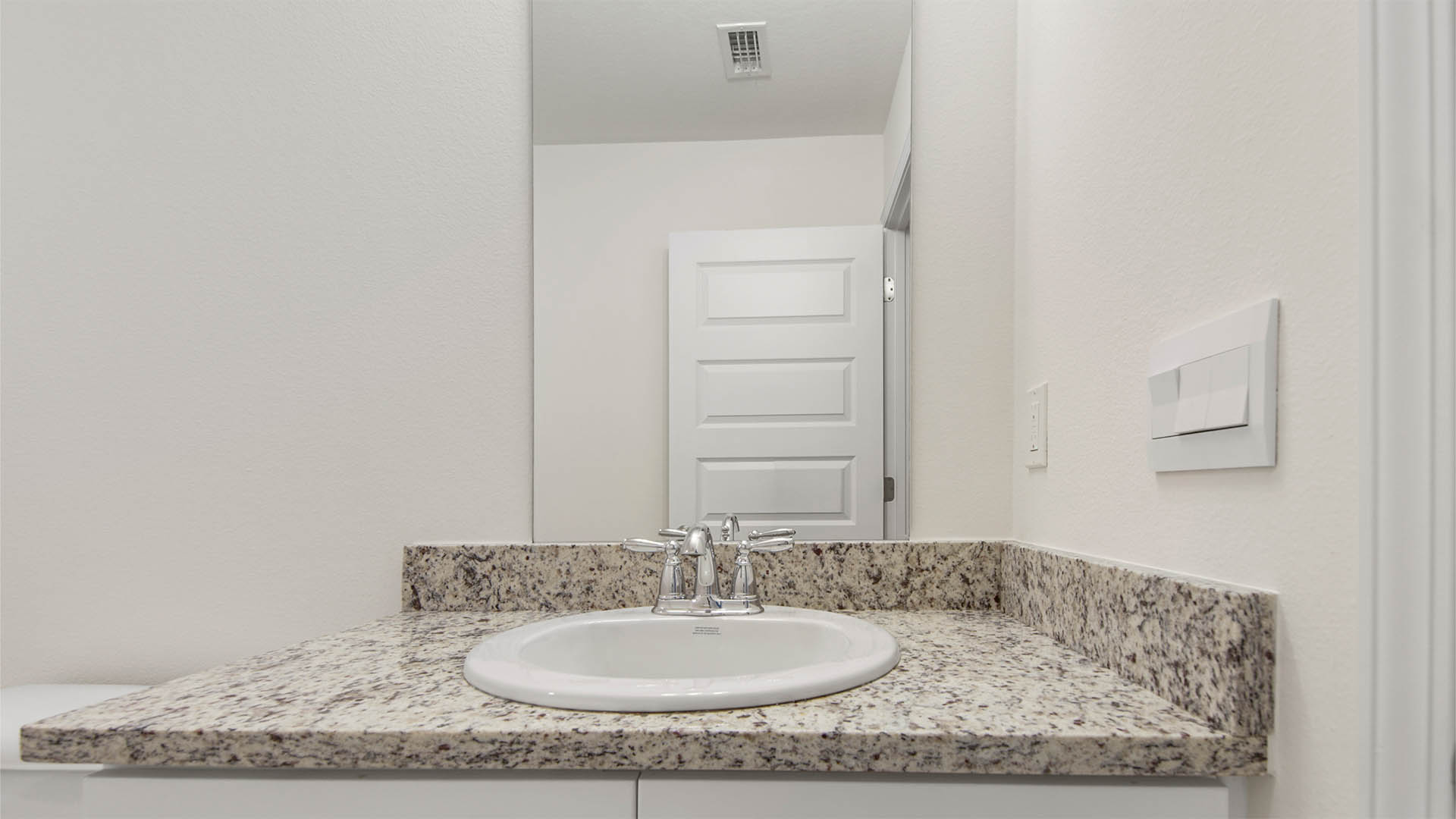 Shared bathroom two with vanity and lower cabinetry
