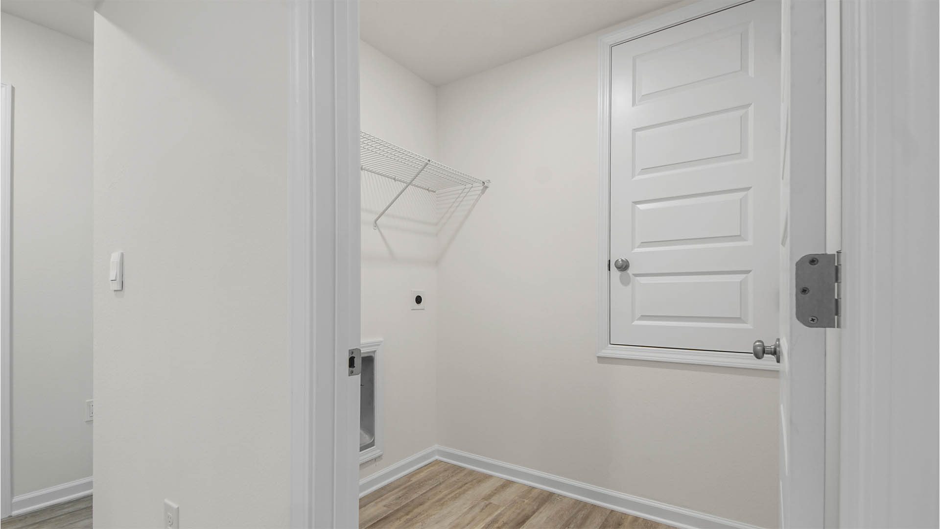 Spacious laundry room with upper shelf