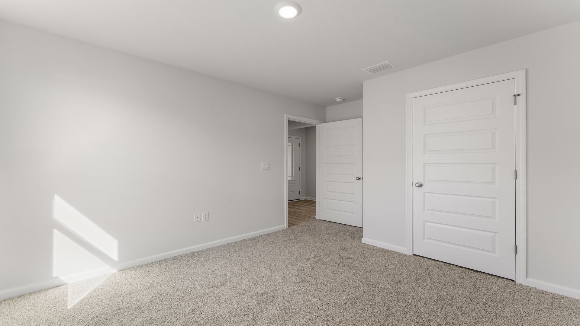The bedrooms located off the front hallway have a shared bathroom between