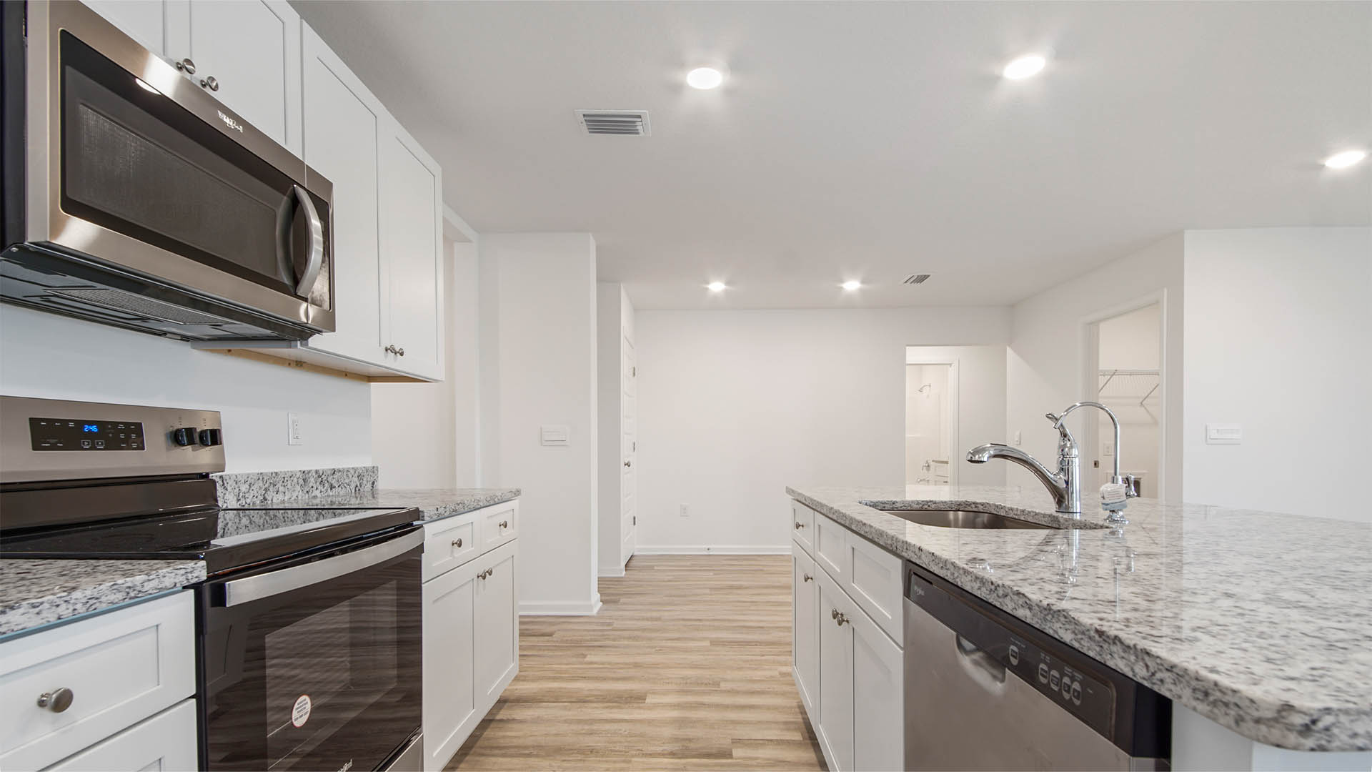 Kitchen with center island with granite countertop and sink and dishwasher for easy meal prep and cleanup