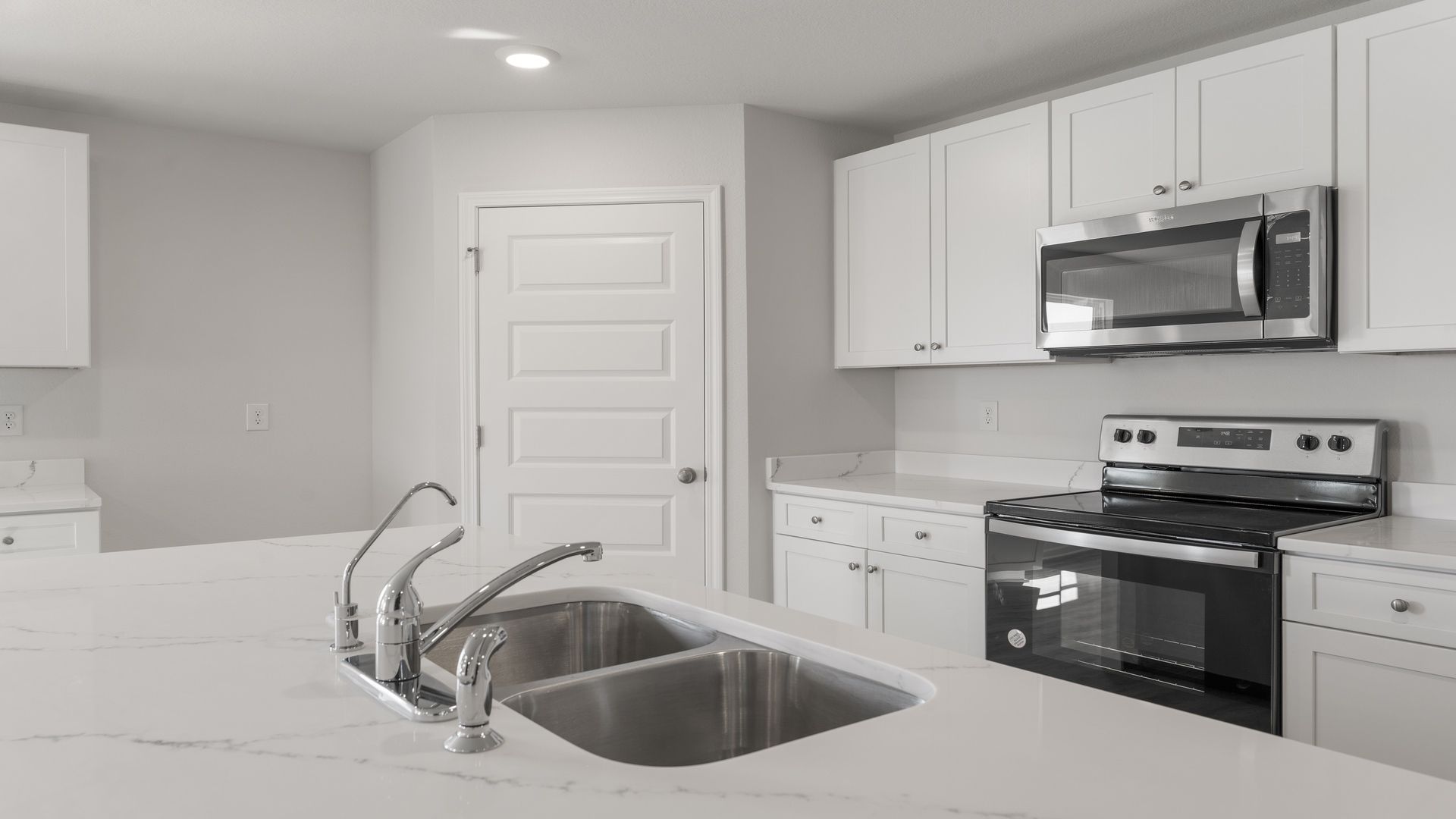 Kitchen with stainless steel appliances including a stove microwave and dishwasher