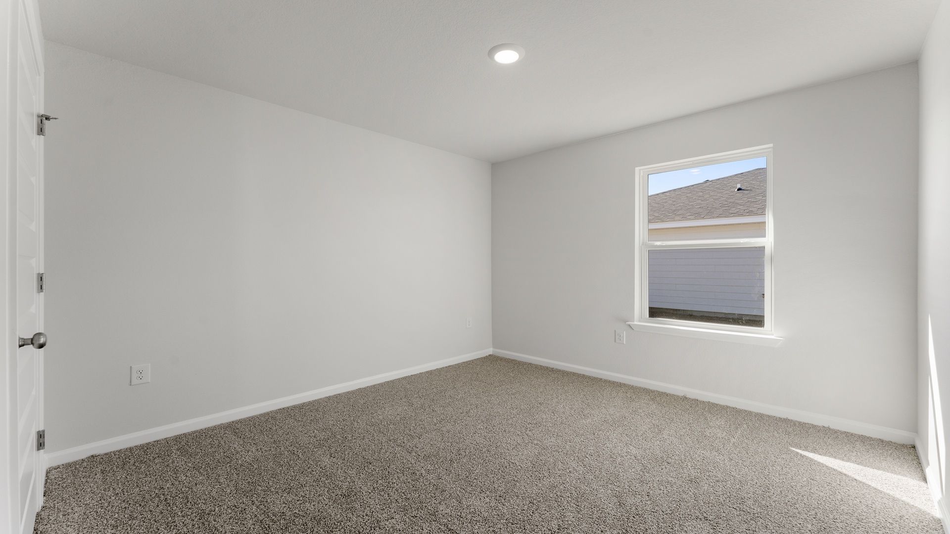 Guest bedroom off the front entry hall with carpet