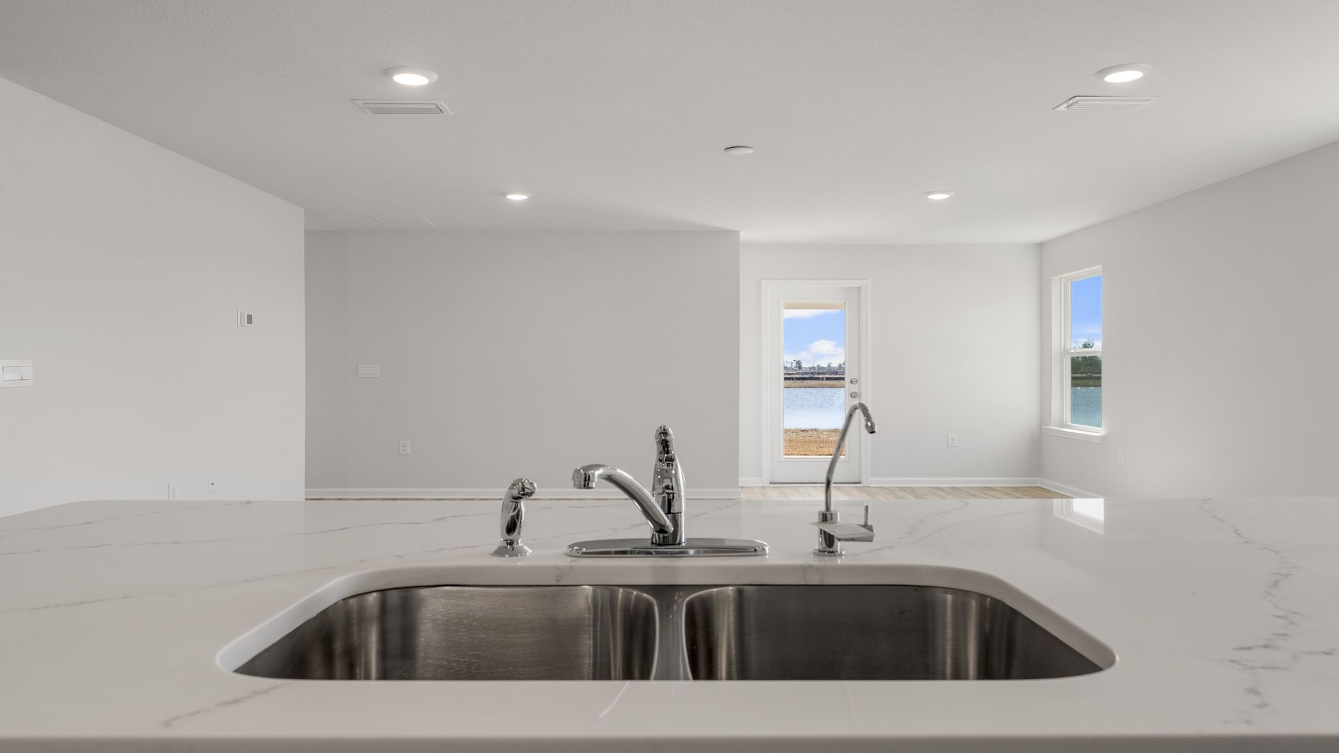 The center island holds the sink and dishwasher