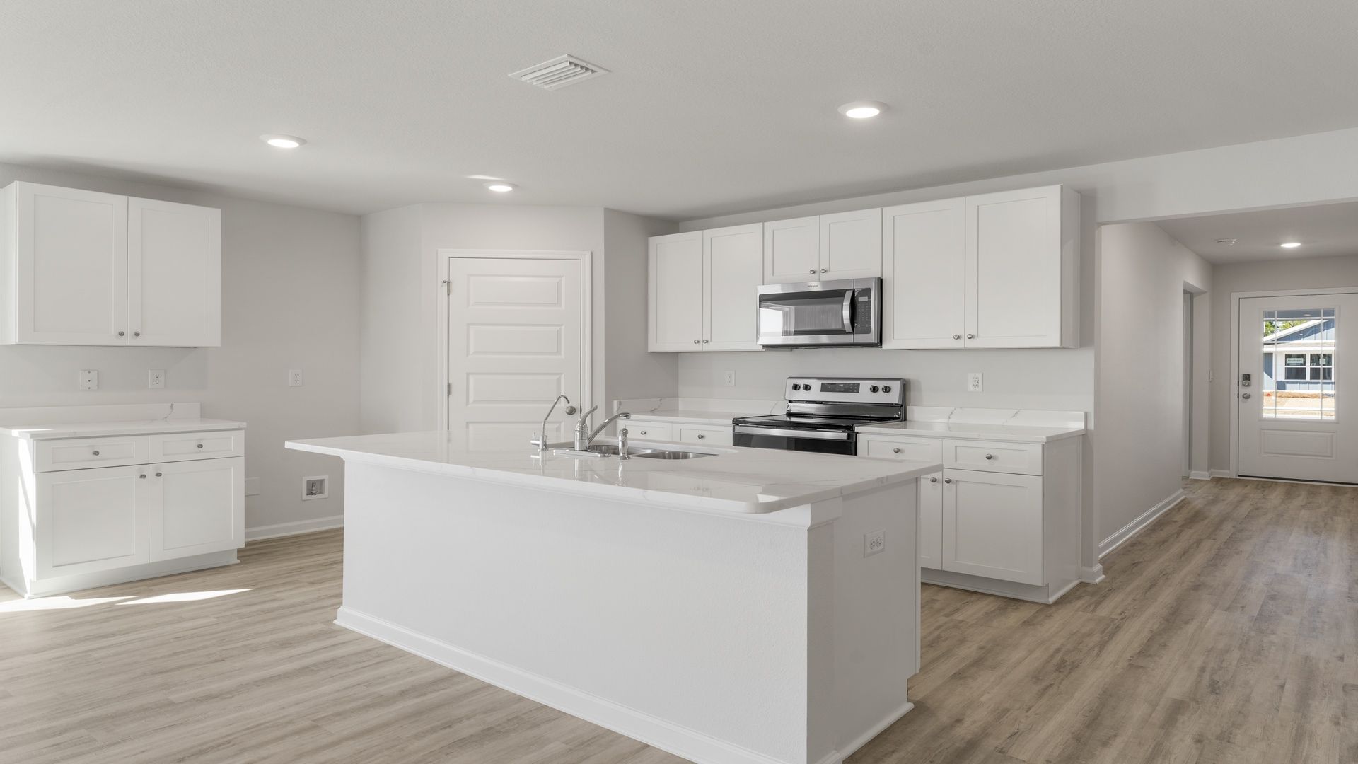 The kitchen has a corner pantry and white cabinetry