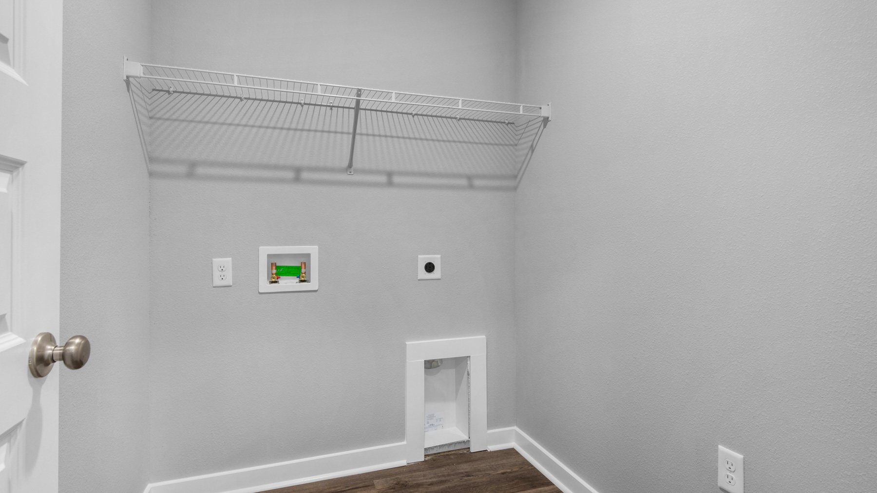 the laundry room is adjacent to the kitchen and has space for a full size washer and dryer