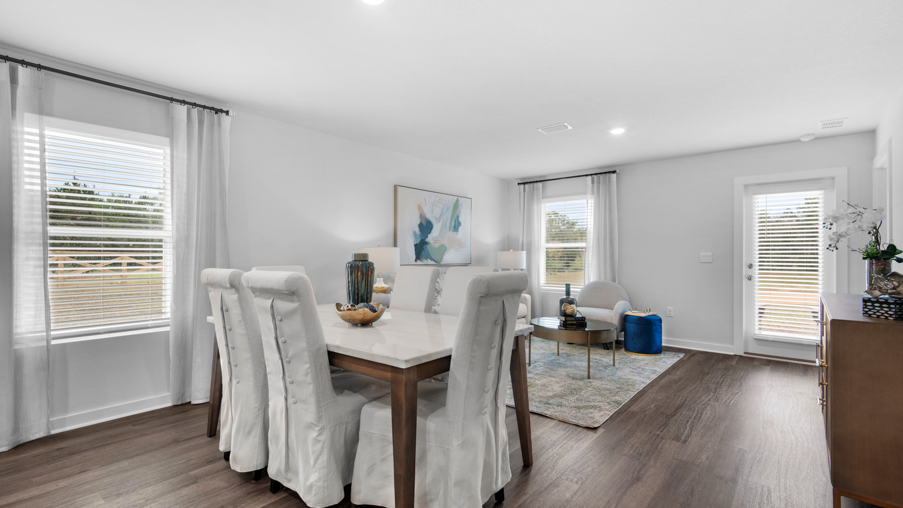 There is an area for a dining table and chairs just past the kitchen