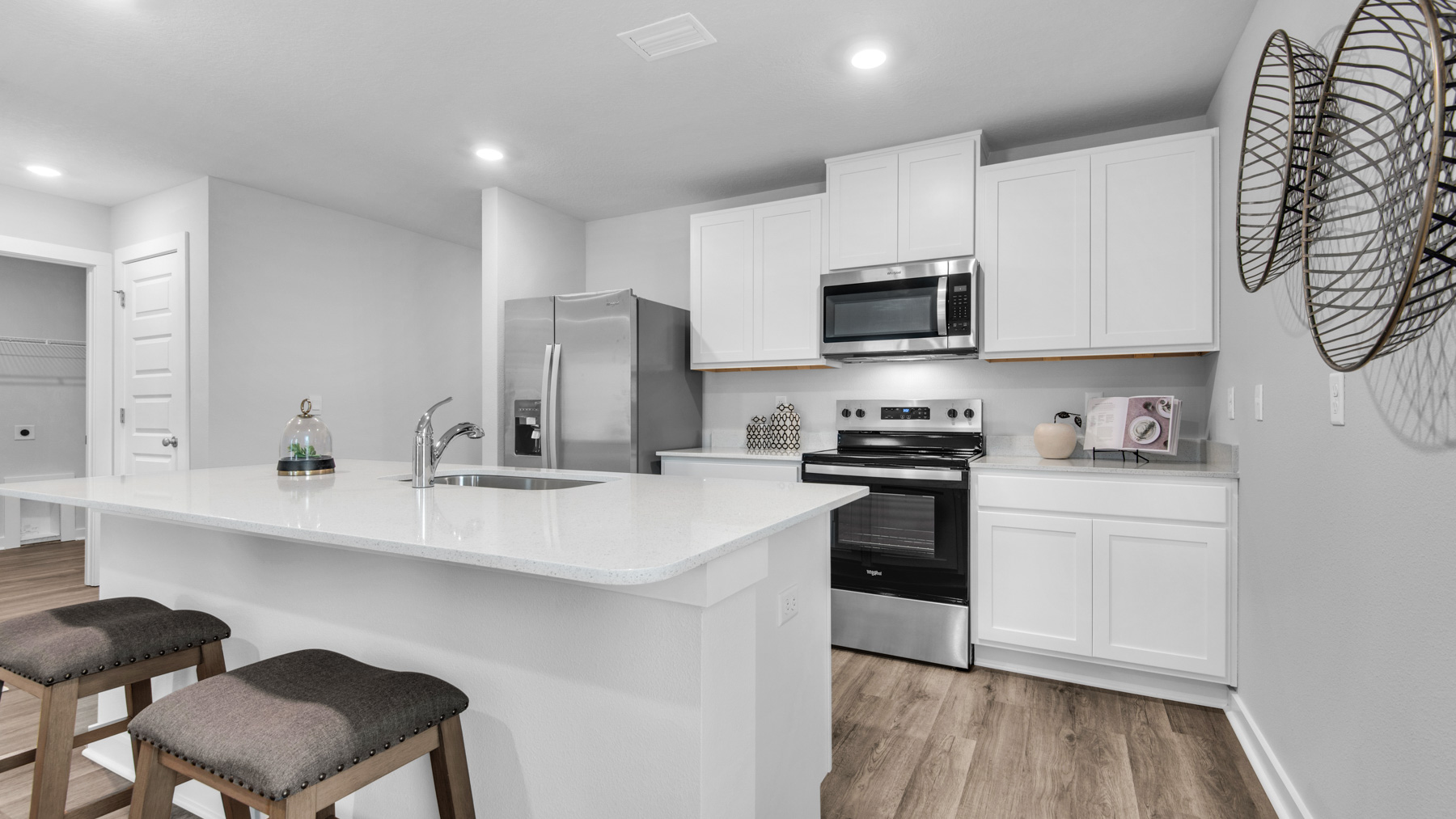 The kitchen has upper and lower cabinetry for storage