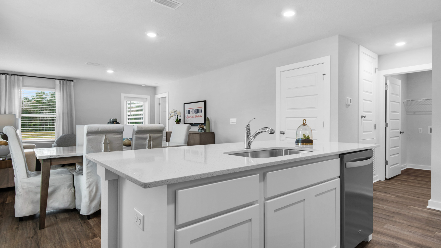 The kitchen island has a sink and dishwasher