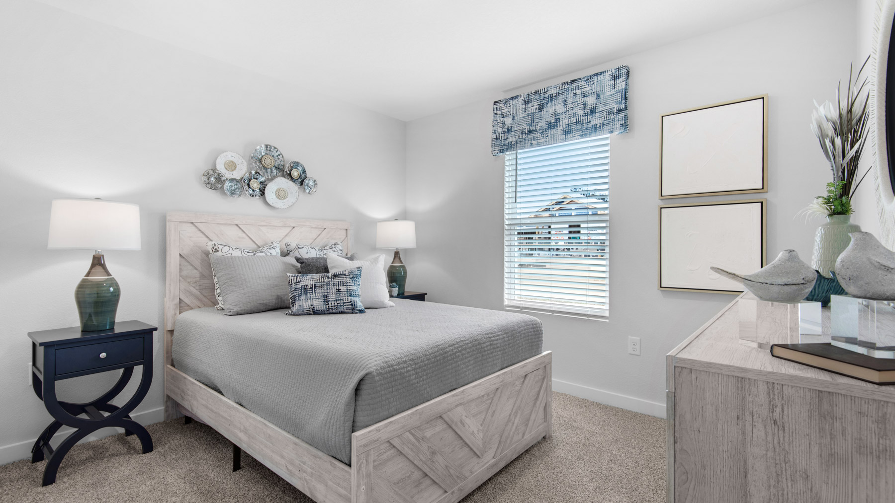Guest bedroom one has ample closet space. This image shows the bedroom staged with a queen size bed