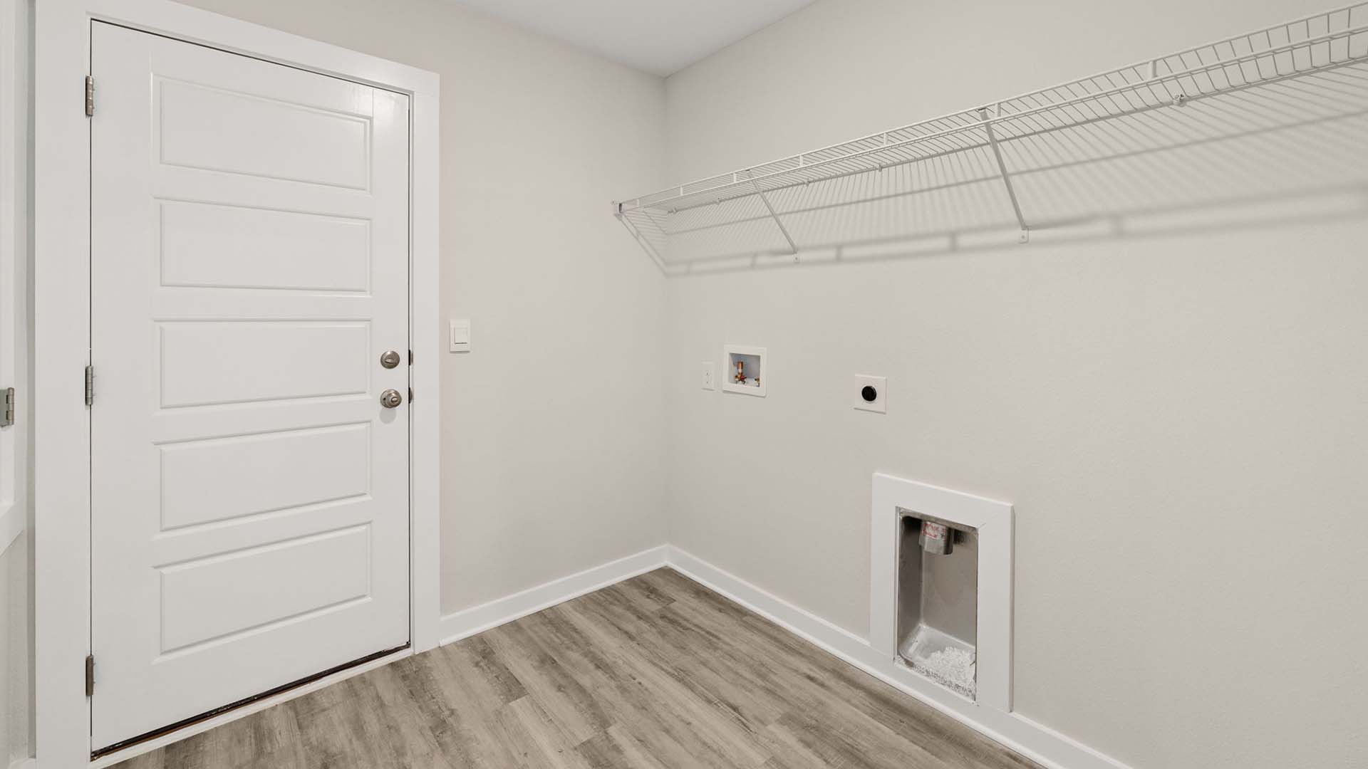 The laundry room gives access to the garage and can hold a full size washer and dryer