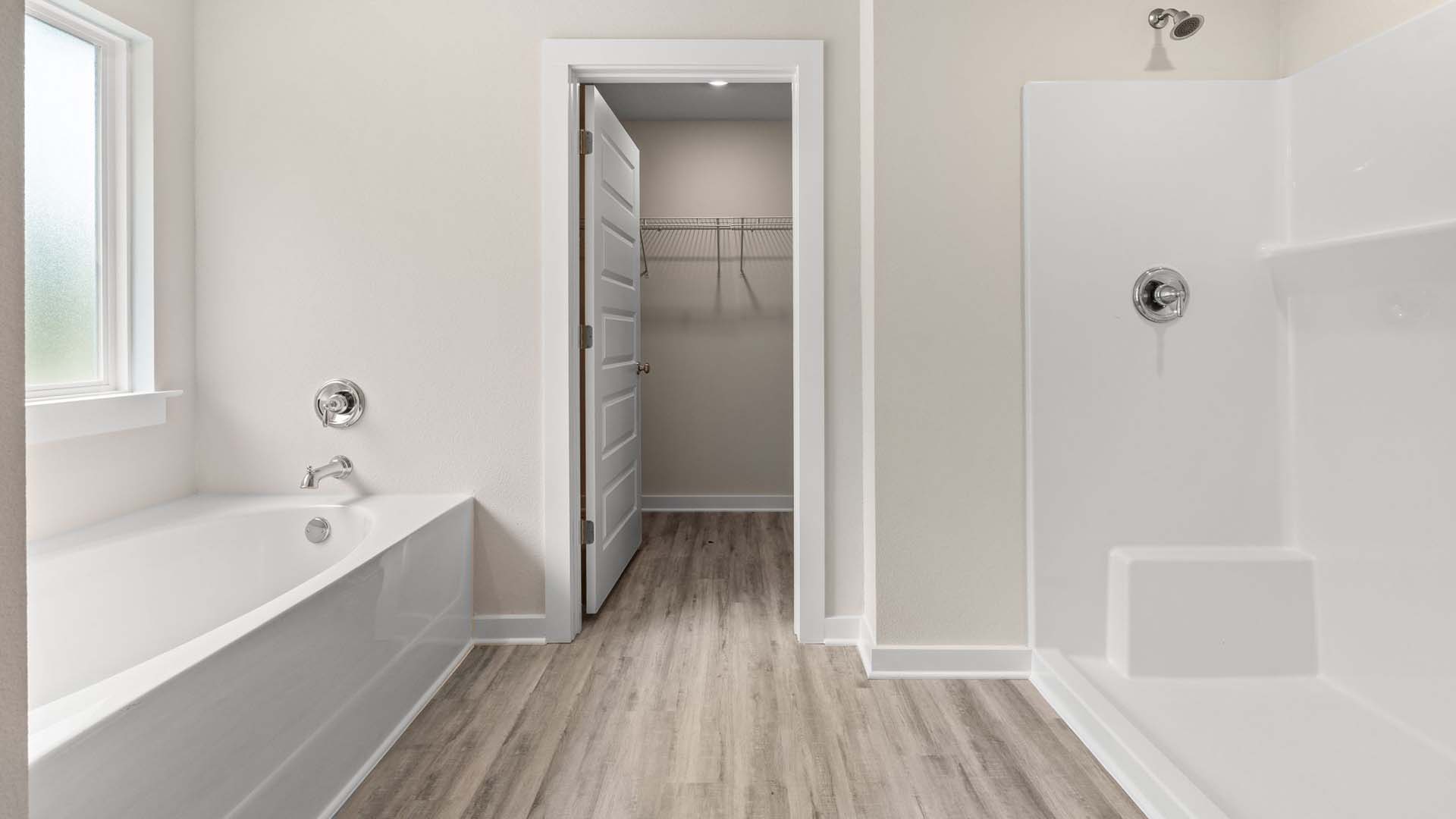 The primary bathroom has a shower and separate soak tub