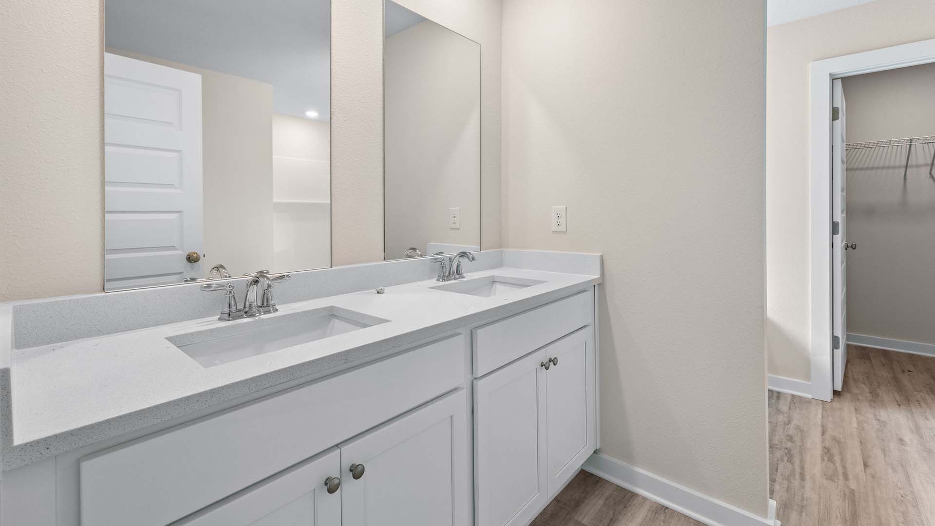 Each bathroom has quartz countertops and lower cabinetry for storage