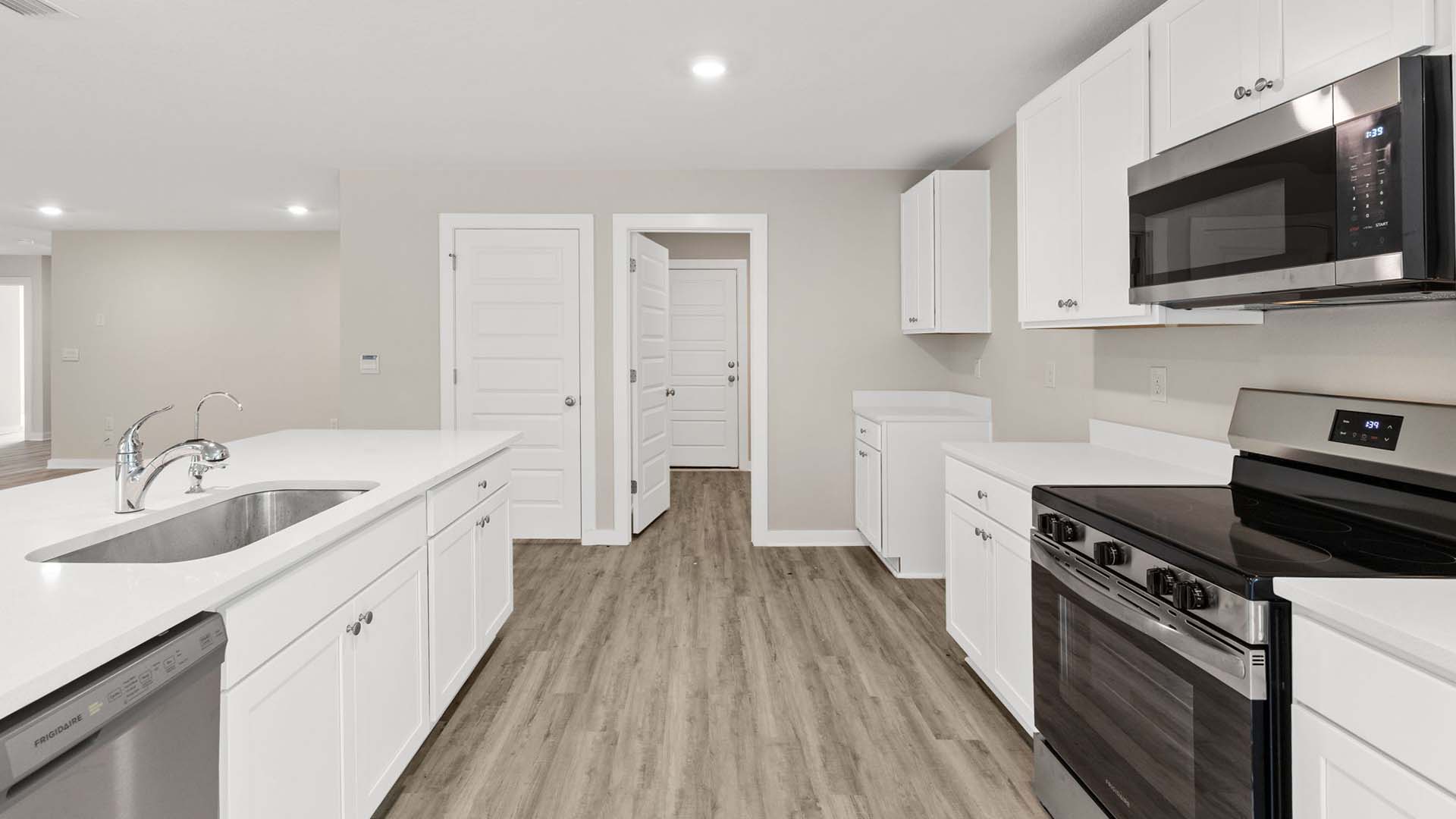 The kitchen has an appliance package that includes a stove, microwave and dishwasher