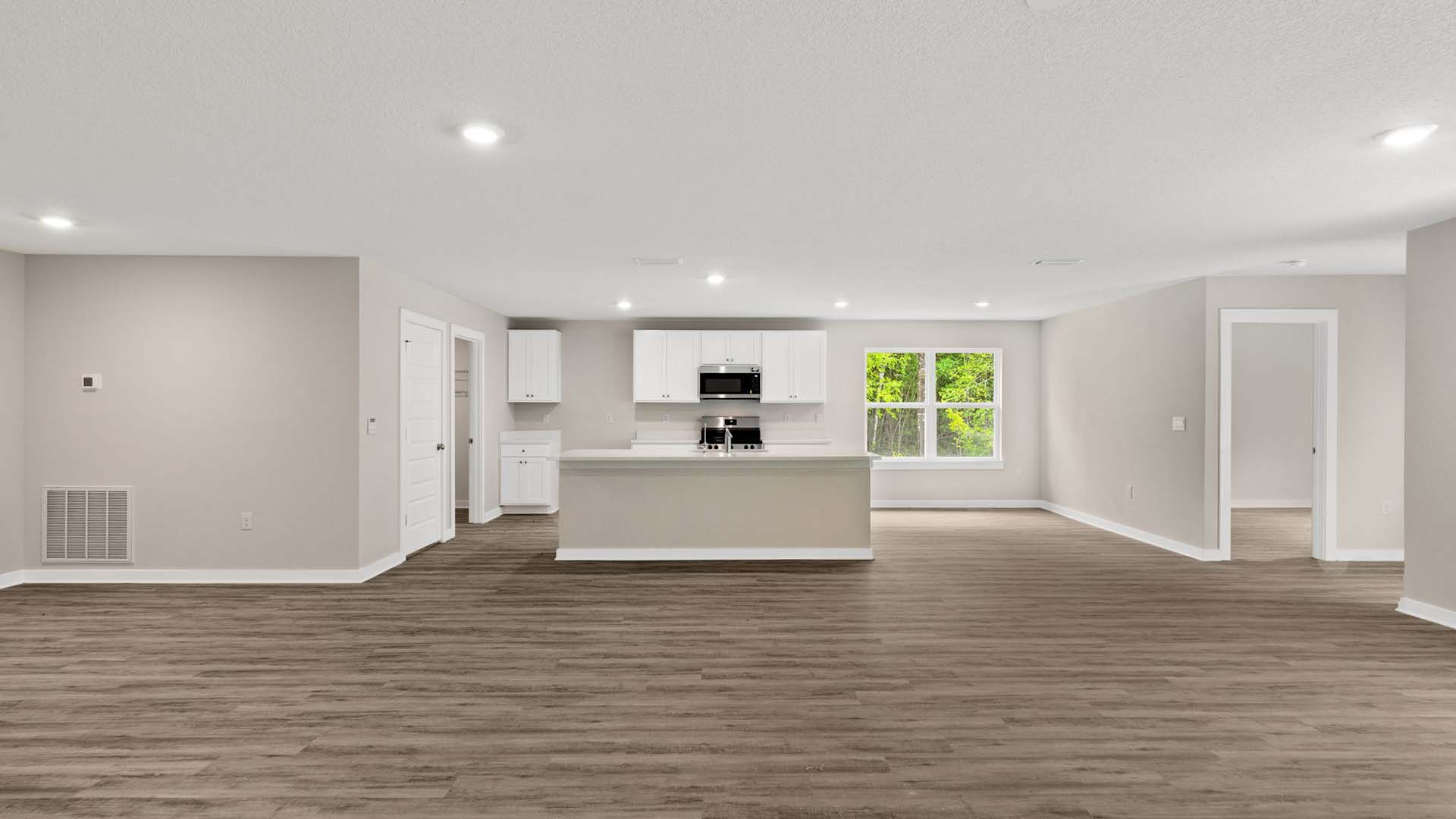 The kitchen has upper and lower cabinetry for storage