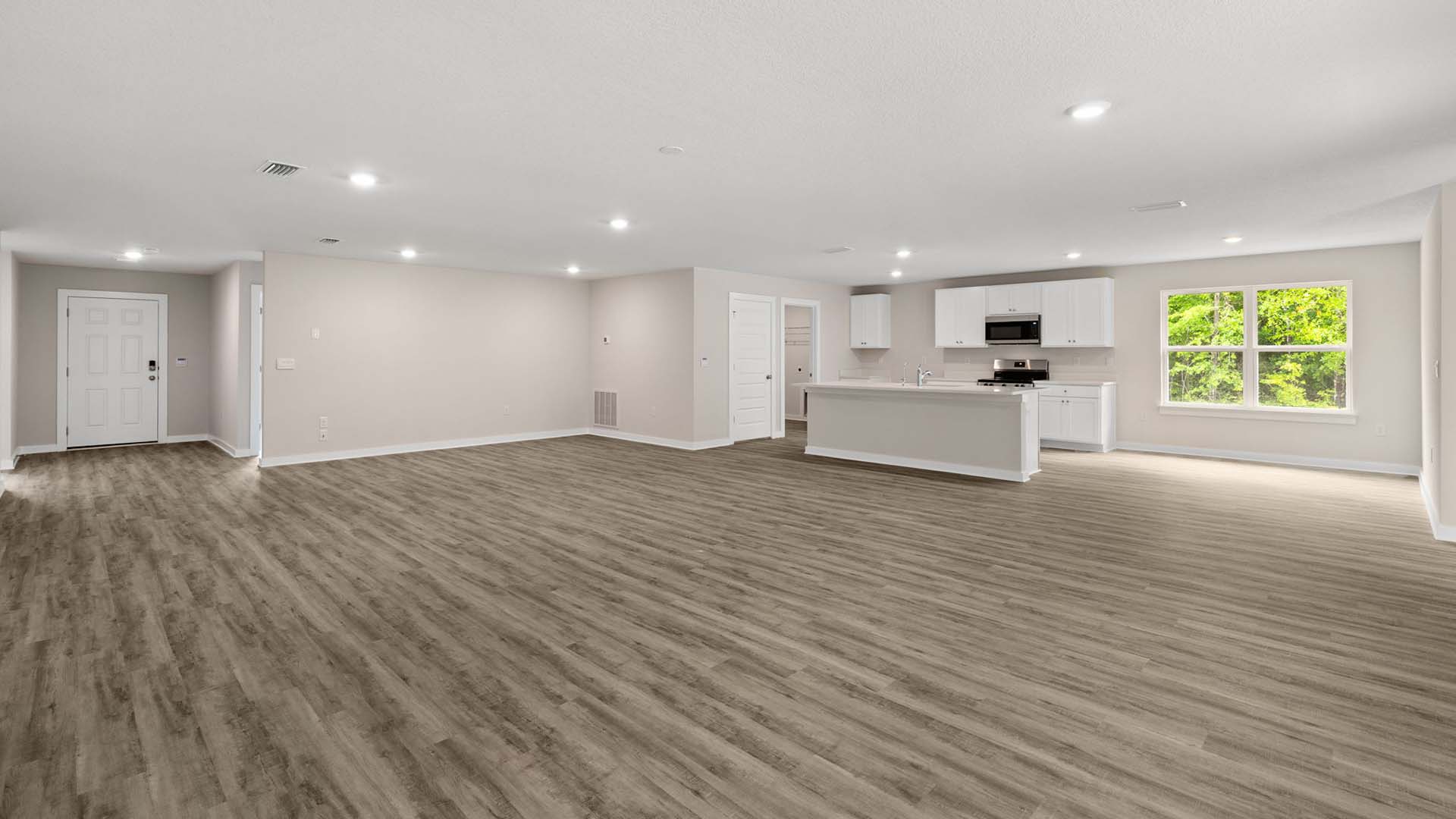 The living area is flanked with windows allowing for natural lighting