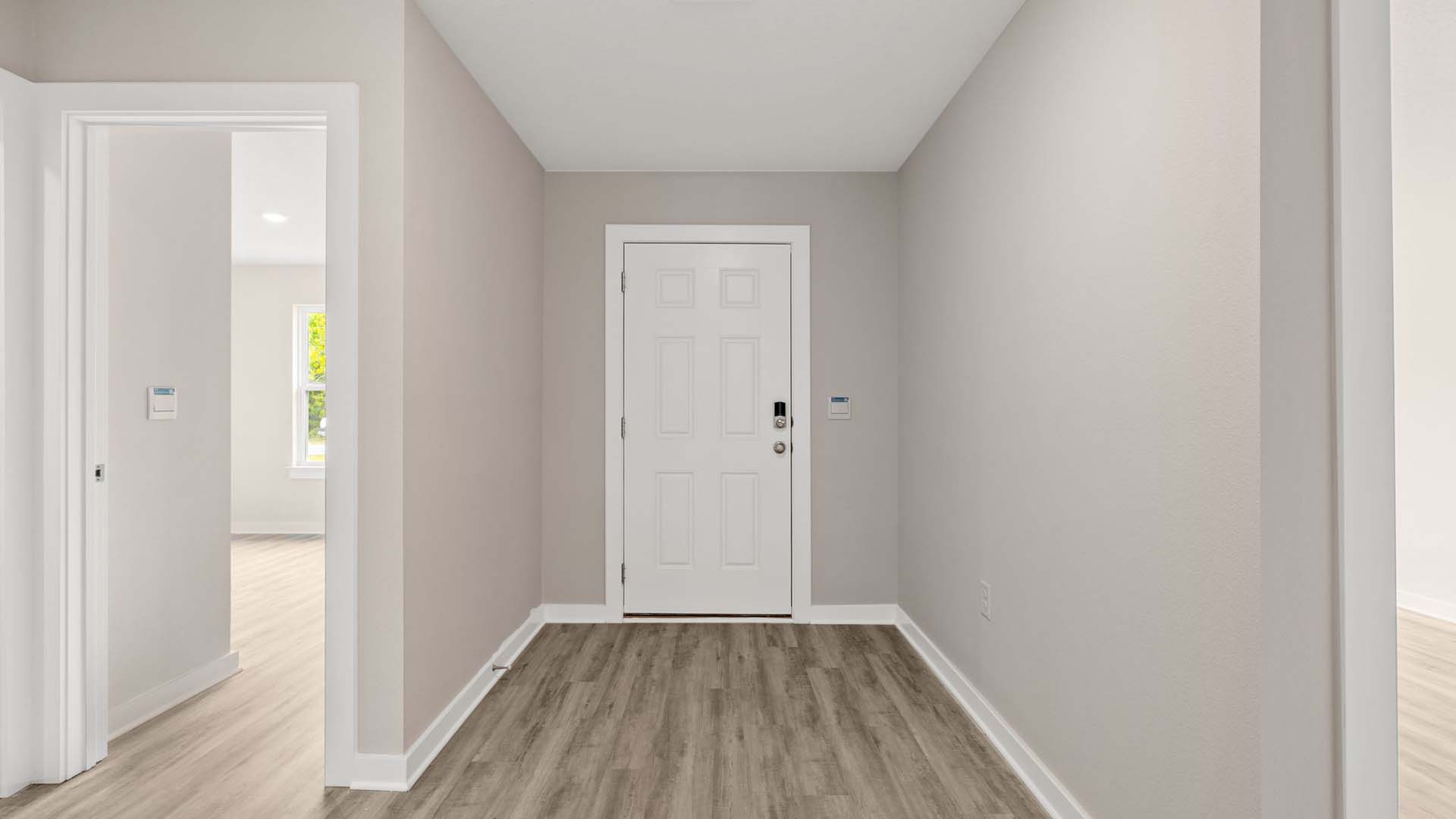 Entry hall with EVP flooring leading to the open concept living area