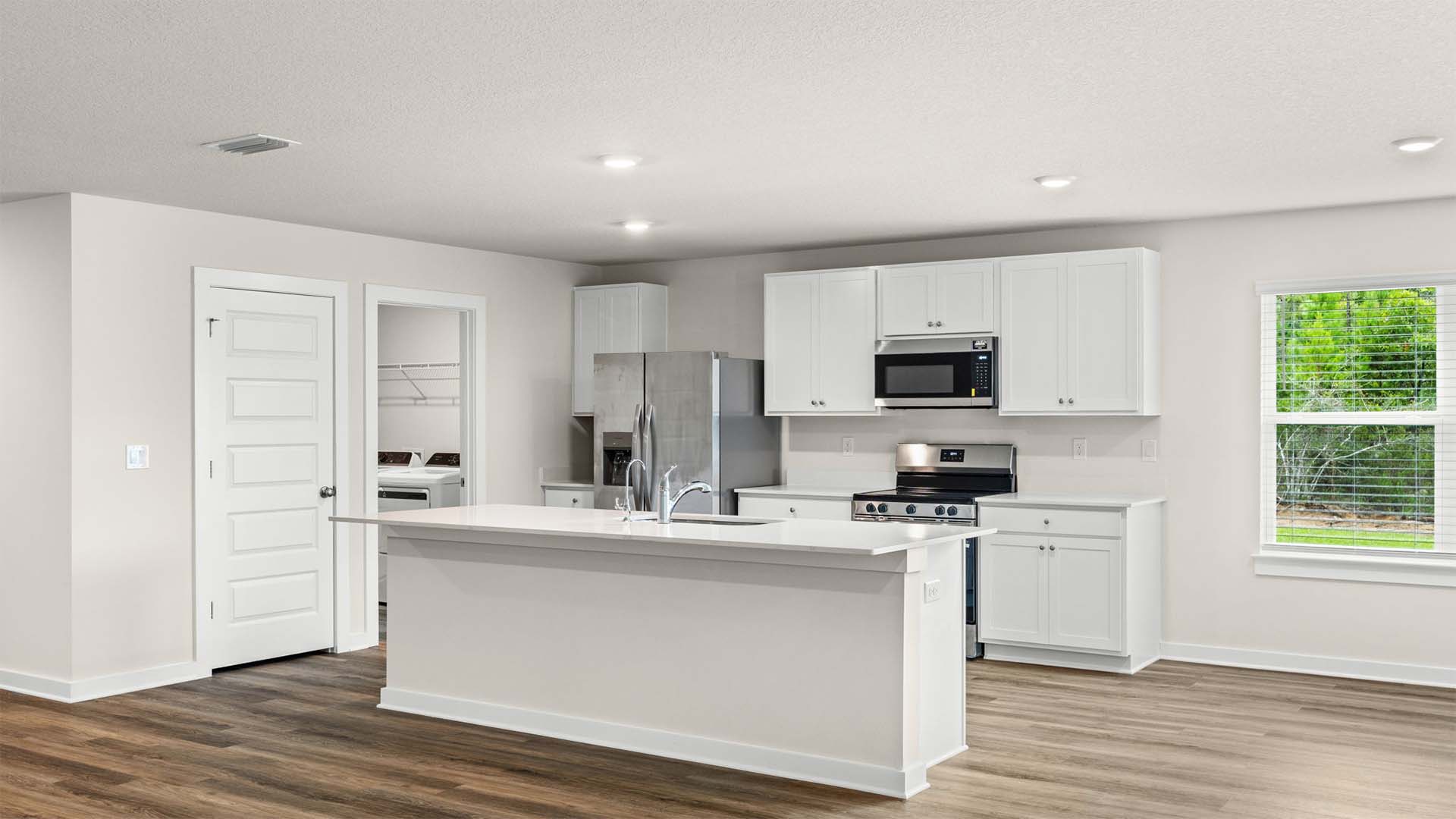 The kitchen has upper and lower cabinetry for storage