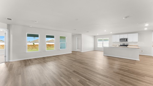 Expansive windows illuminate the living area