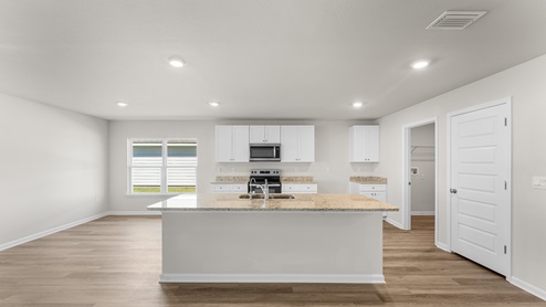 The kitchen has a center island with sink and dishwasher