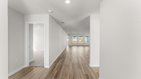 The entry hall to three additional bedrooms and the open living area
