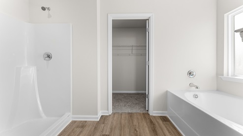 The primary bathroom has a separate shower and soak tub
