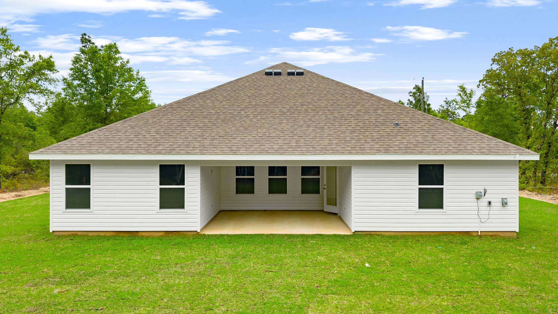 The back of the Sawyer that is constructed with vinyl siding.