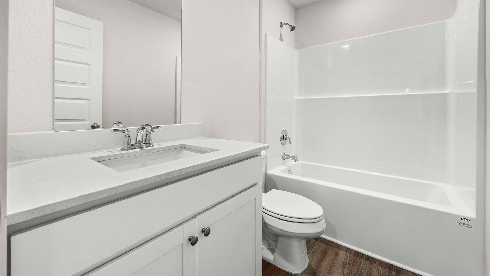 There is a full bathroom located near the fourth guest bedroom off the living area
