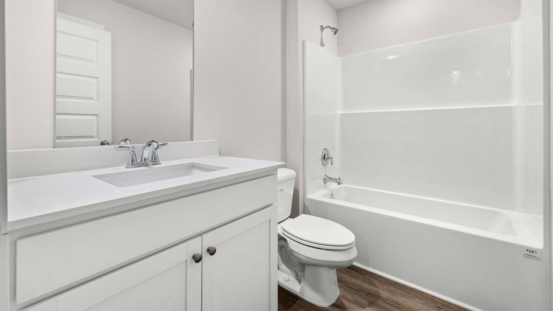 Another shared bathroom is off the entry hall at the front of the home with three bedrooms