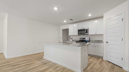 Kitchens with granite countertops and white cabinetry