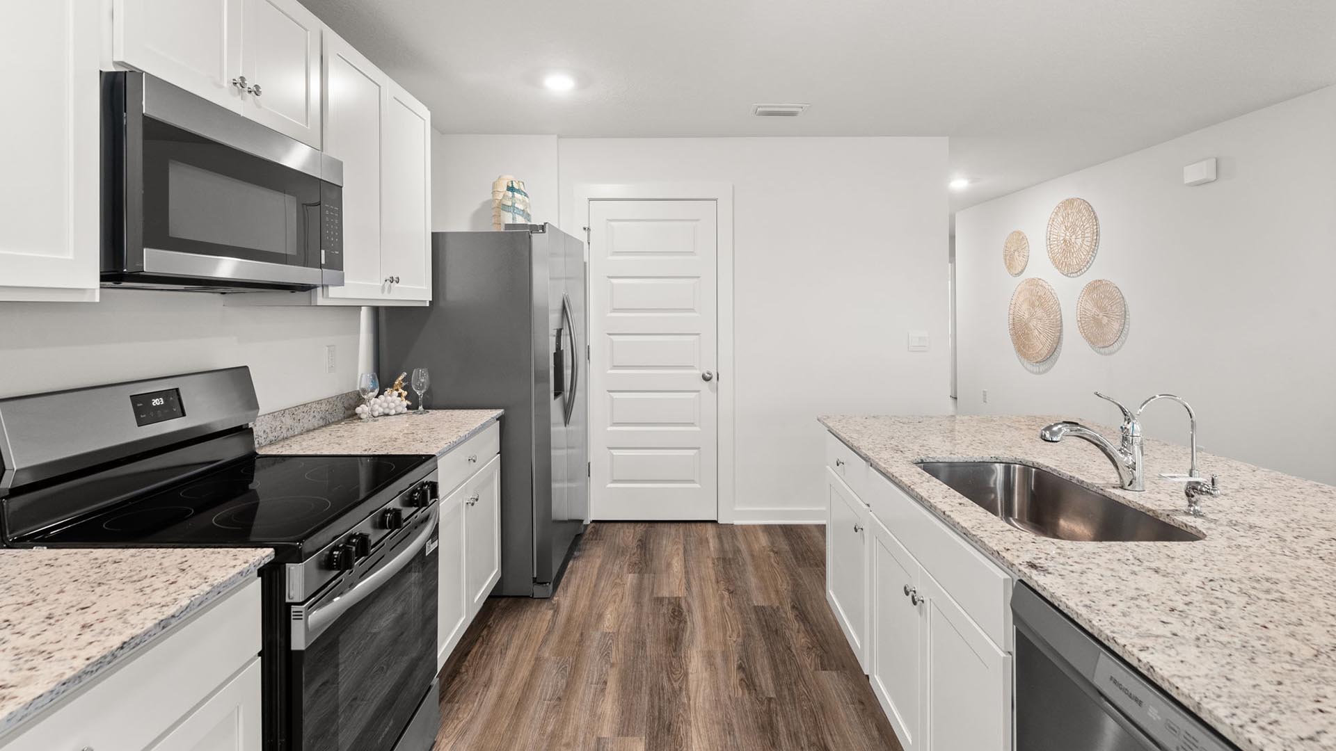 This kitchen has appliances including a smooth top stove, microwave and dishwasher