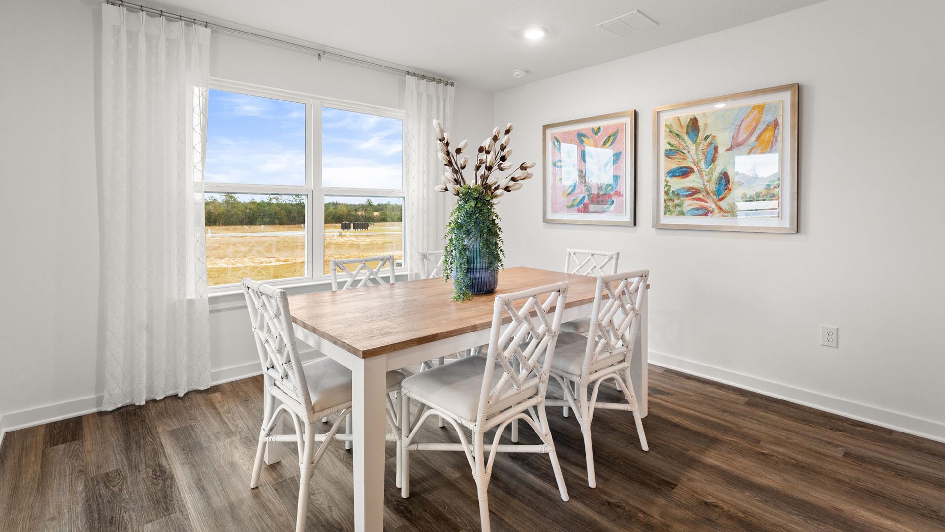 The dining area has a large picture window allowing for natural light