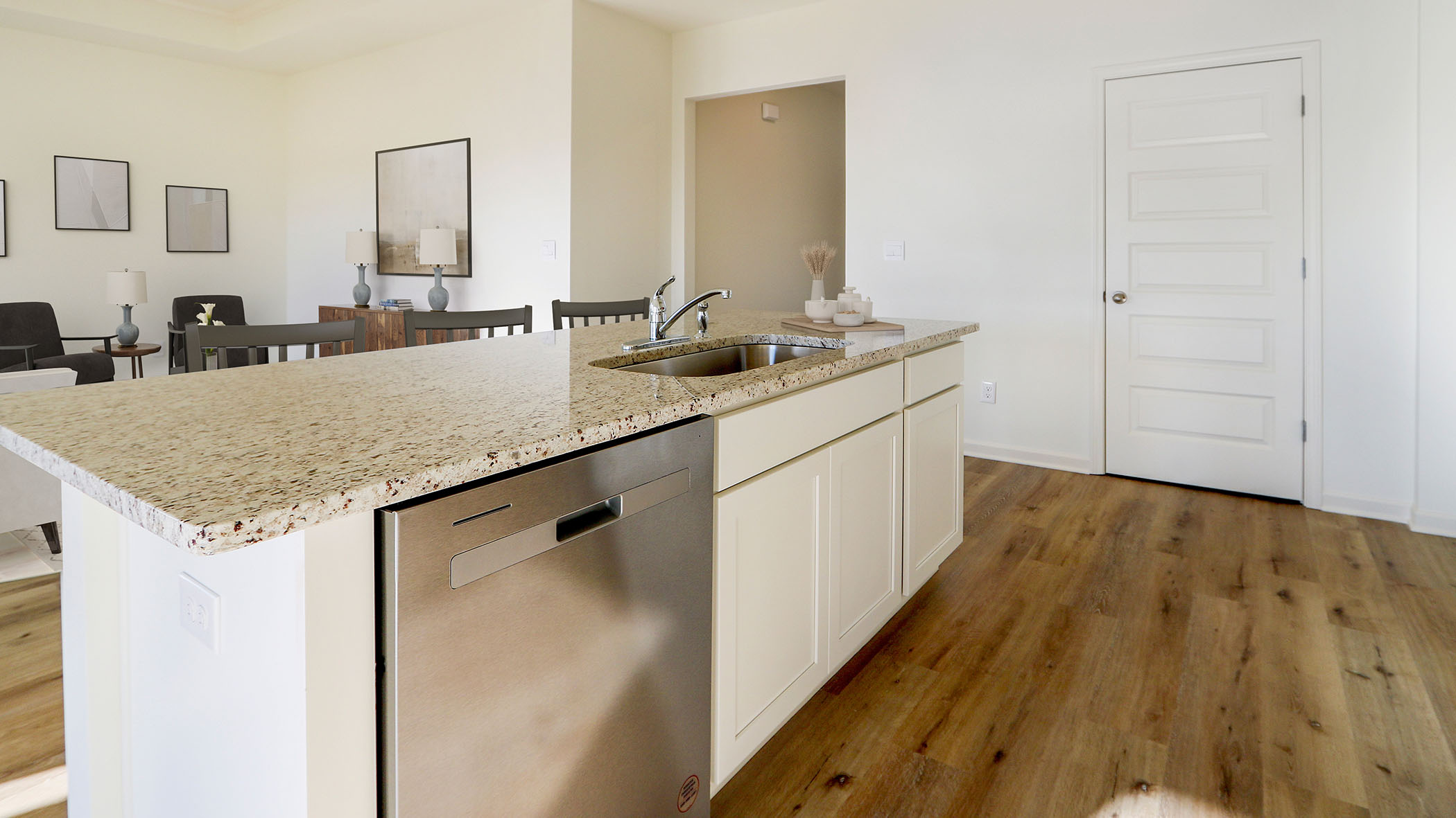 The kitchen island has a sink and dishwasher