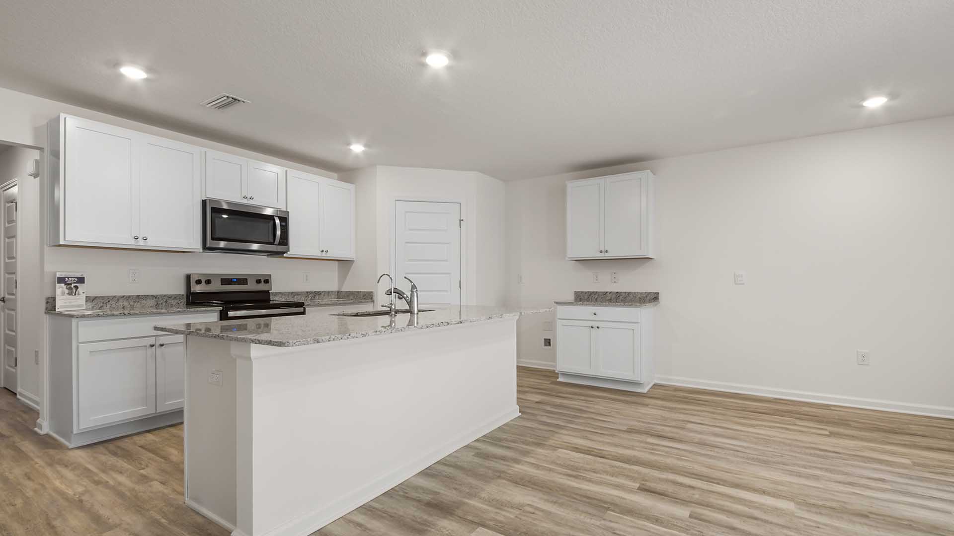 The kitchen has a pantry and upper and lower cabinetry for storage