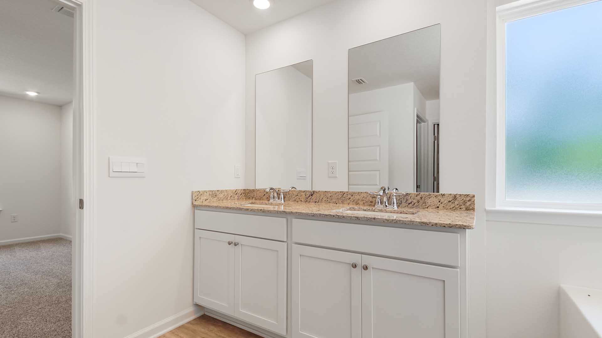 The vanity has lower cabinetry for storage