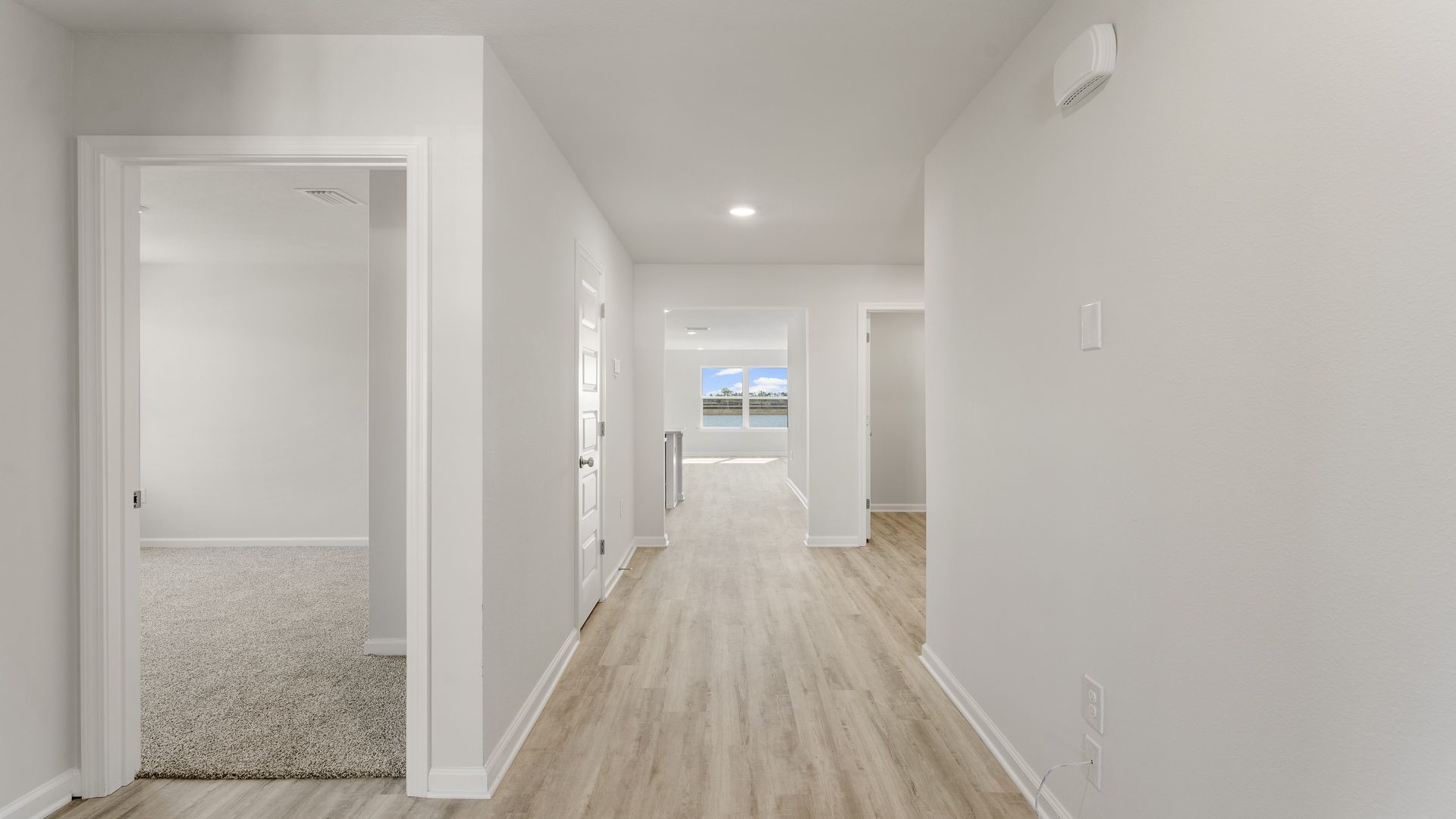 Foyer with EVP flooring leading to the open concept living area