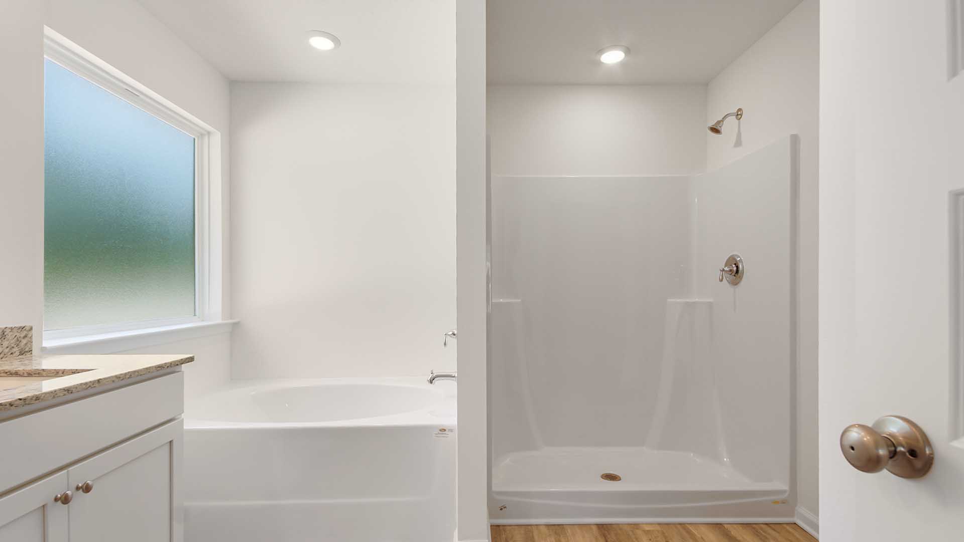 The primary bathroom has a shower and separate soak tub