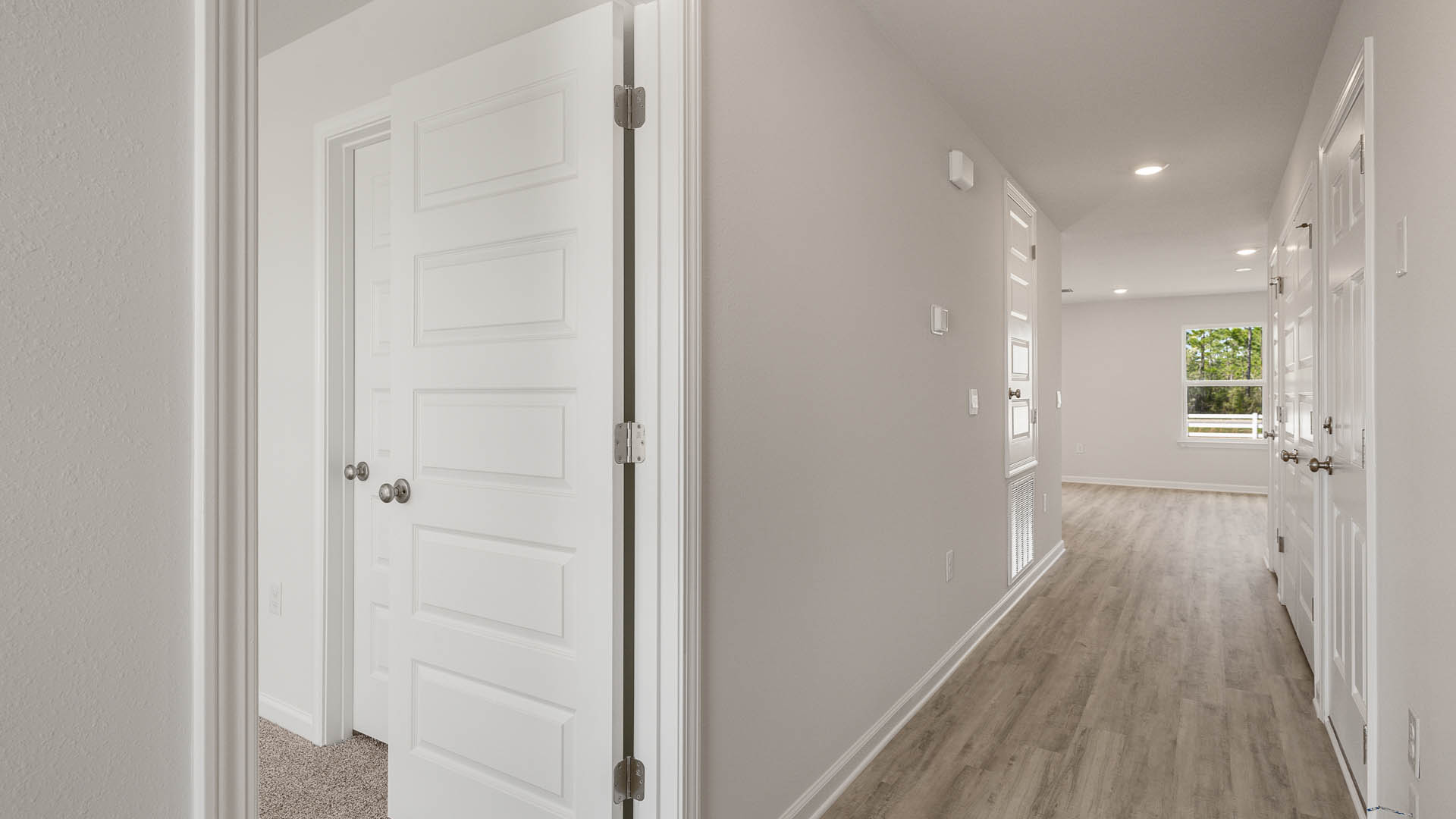 The entry hall leads to the spacious living area with EVP flooring
