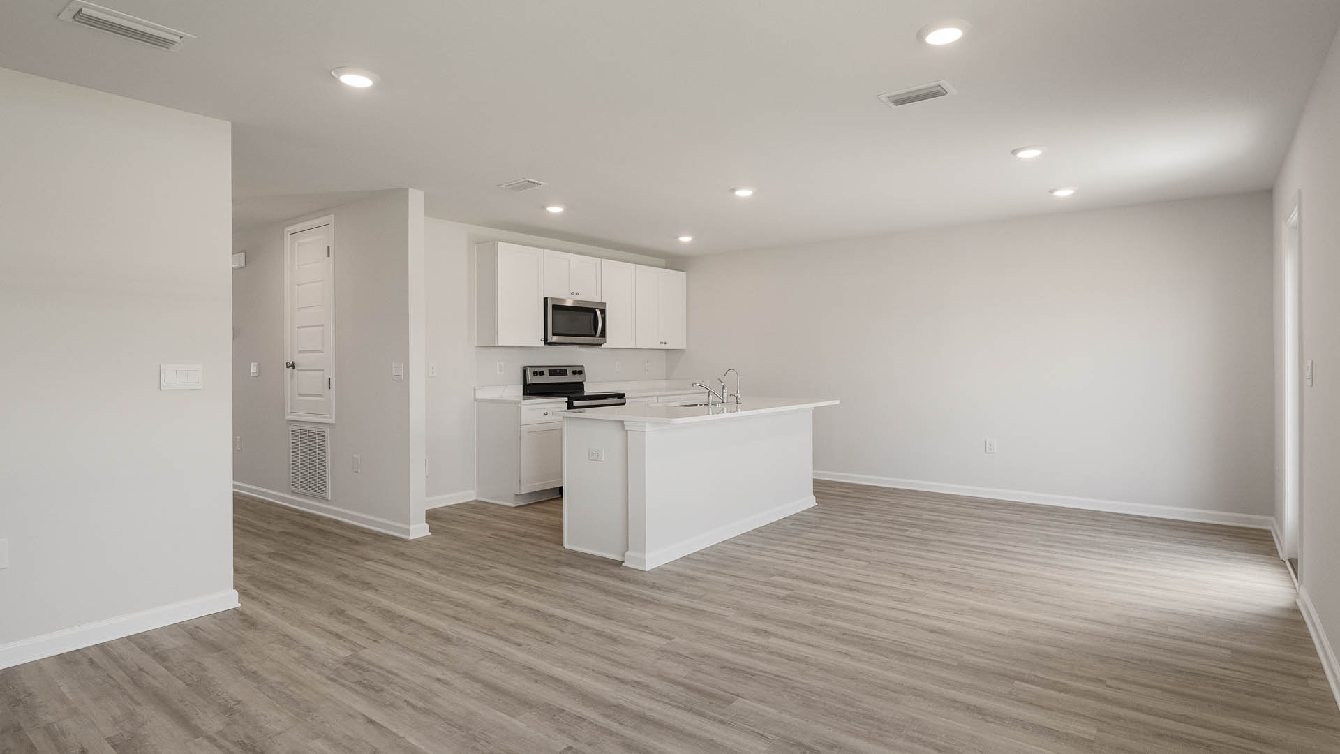 The open concept design includes a space for a living room suite