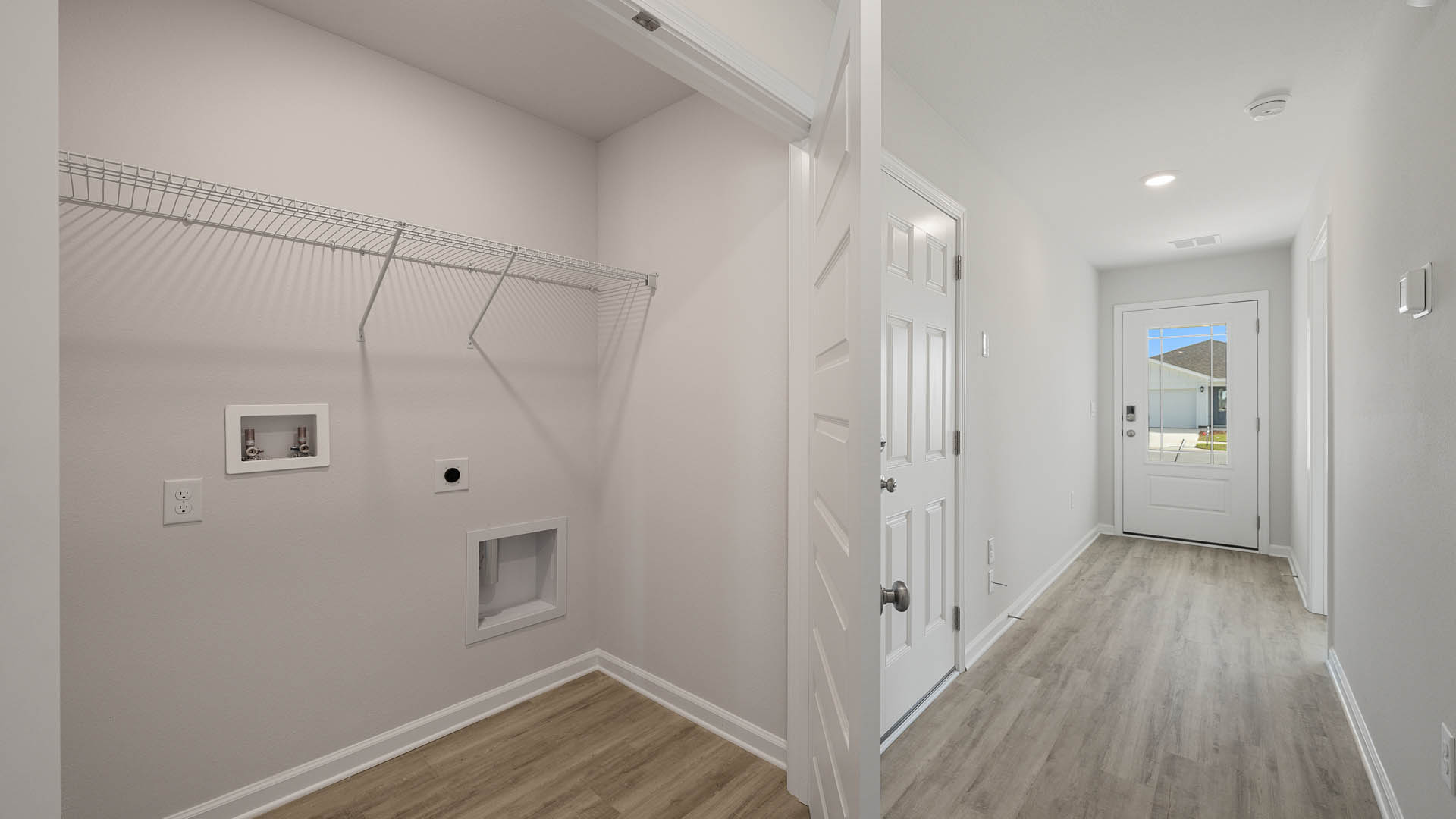 The laundry area is located off the entry hall