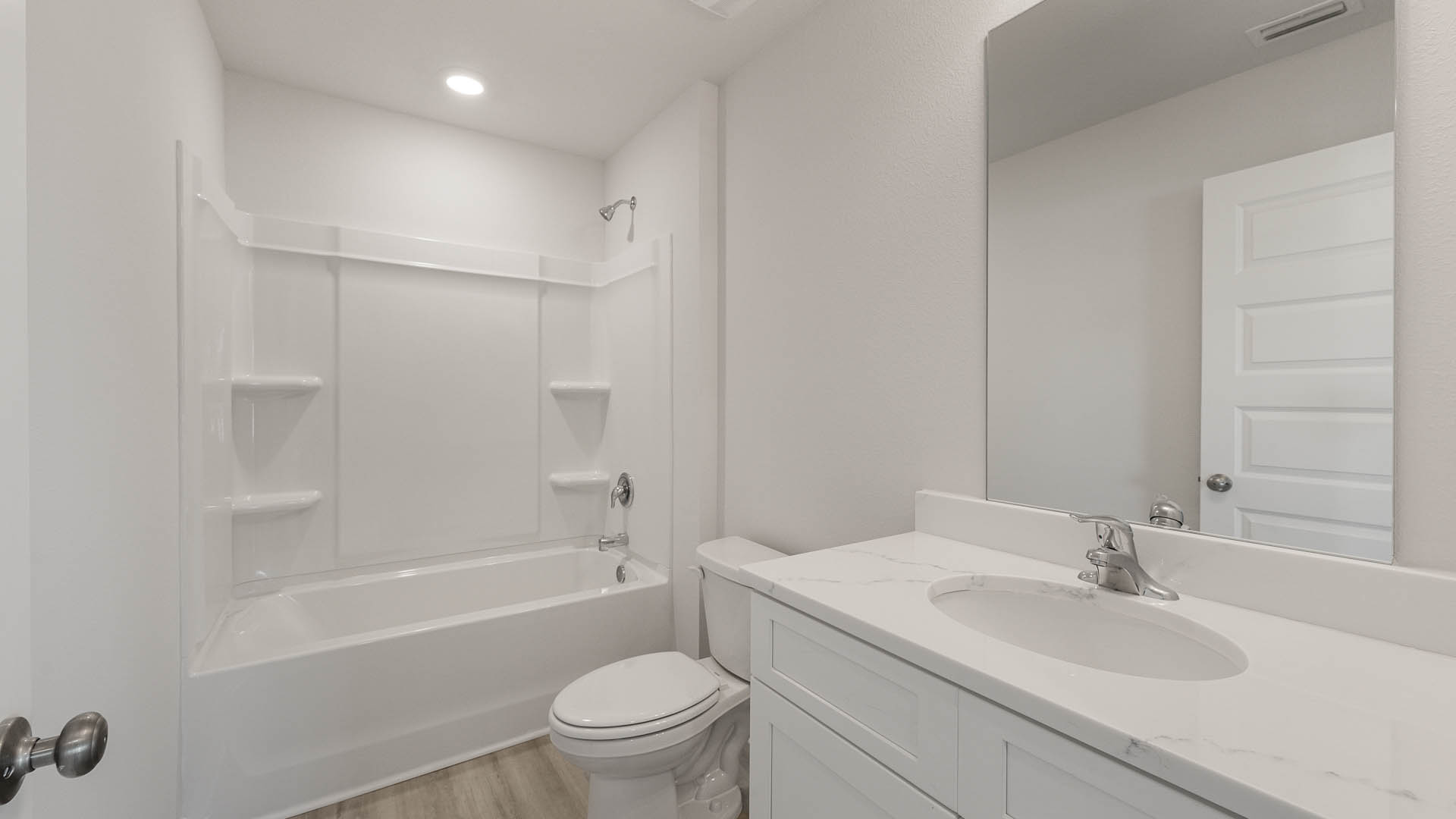 There is a shared bathroom is between the guest bedrooms and has a single vanity and shower tub combination