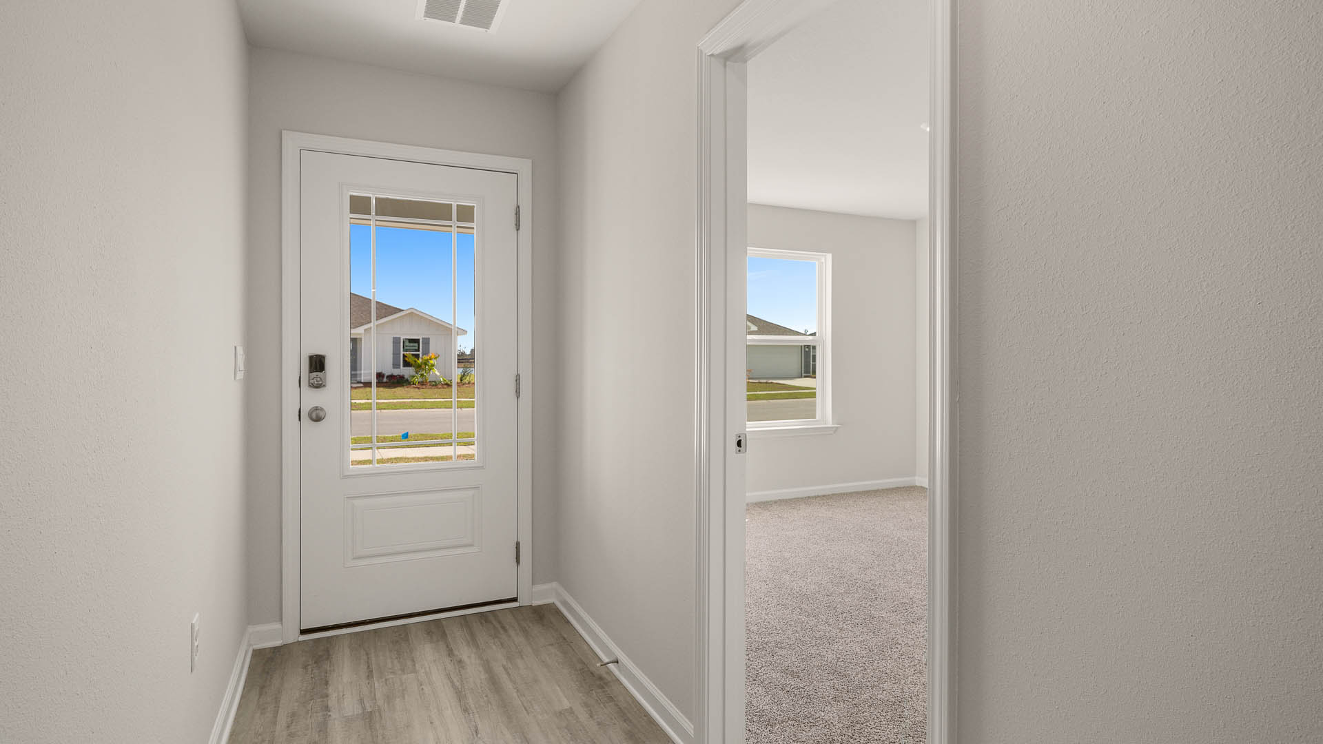 Bright entry hall with the primary bedroom at the front of the home